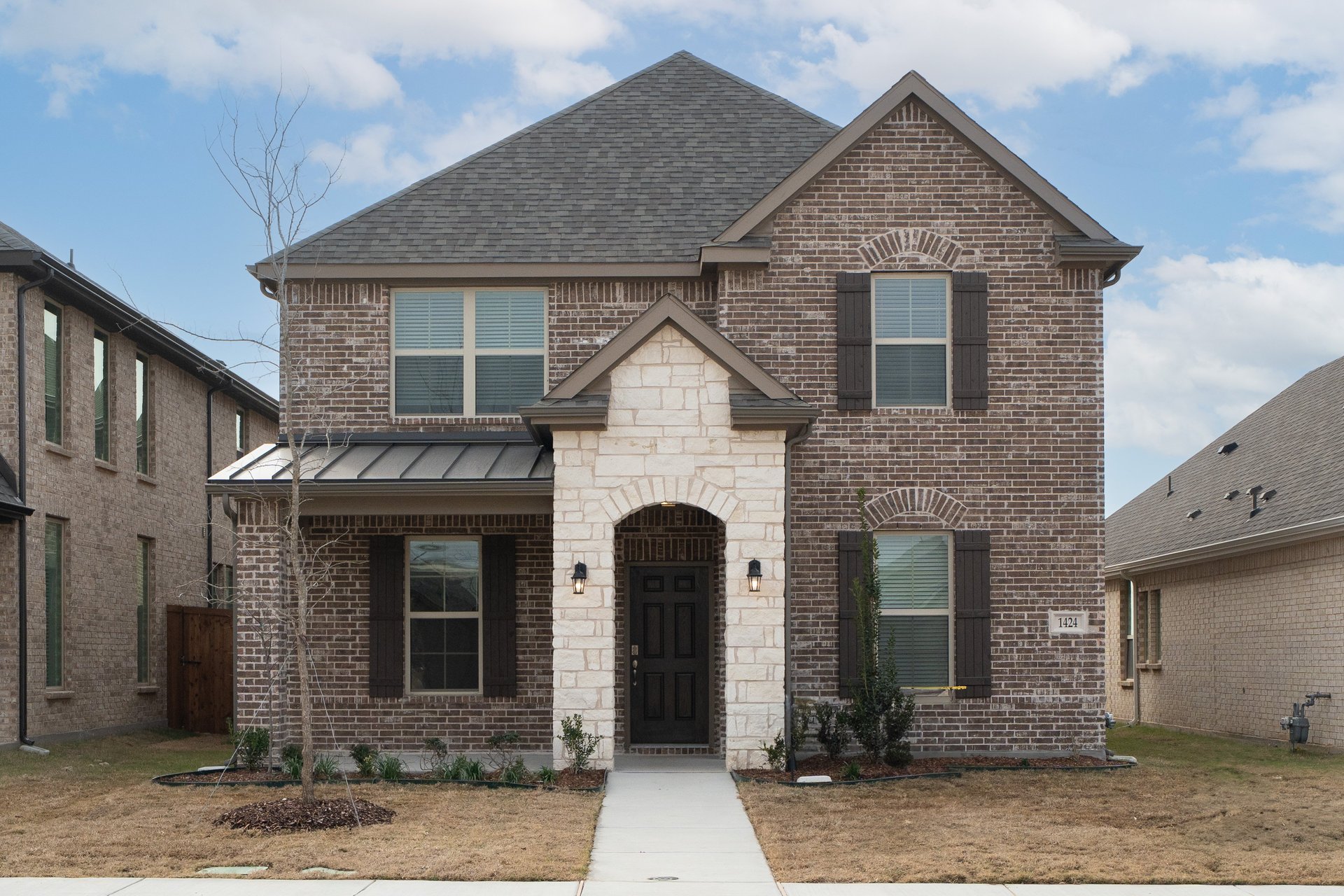 two-story home with brick and stone exterior