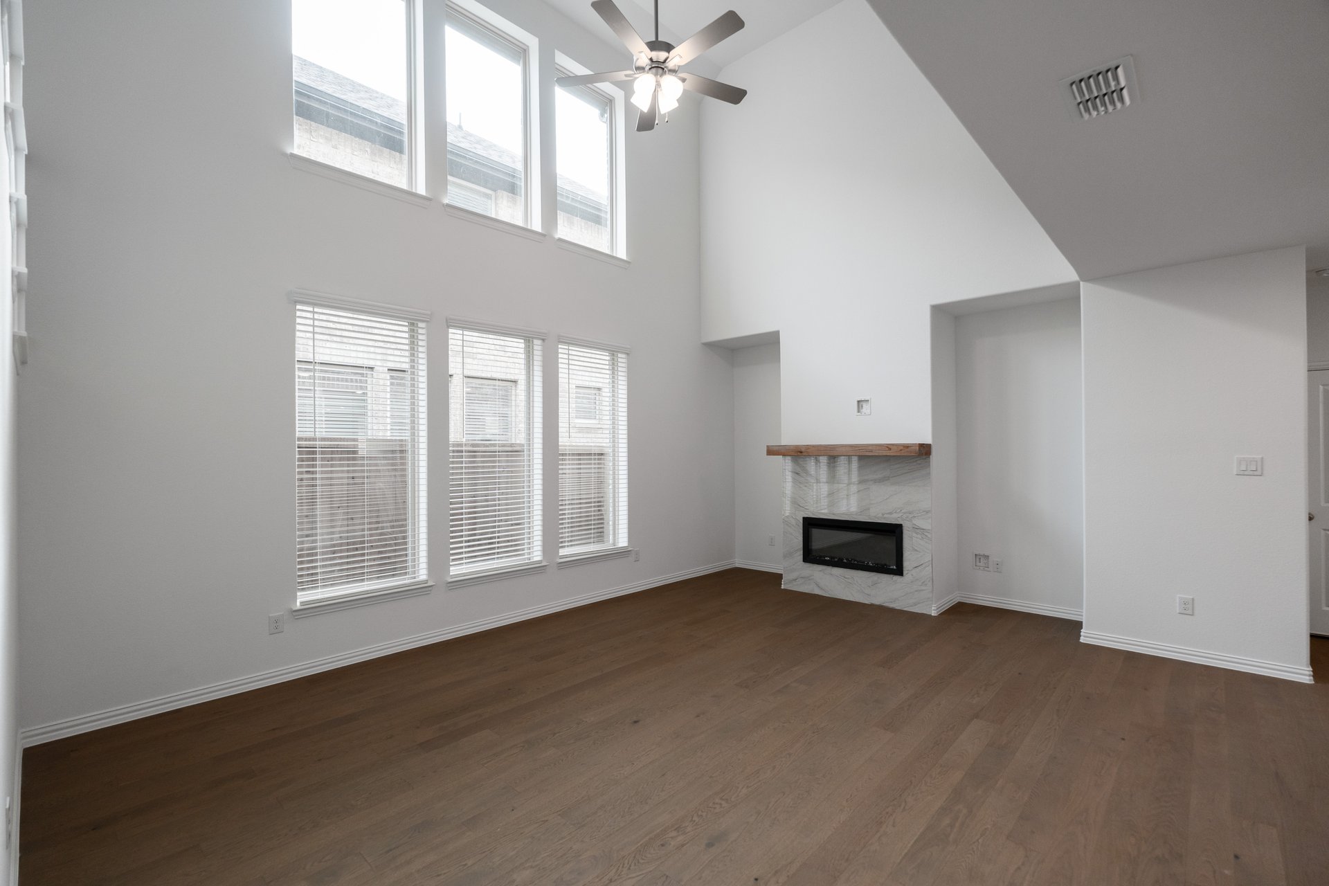 open great room with wood floors and tall ceilings