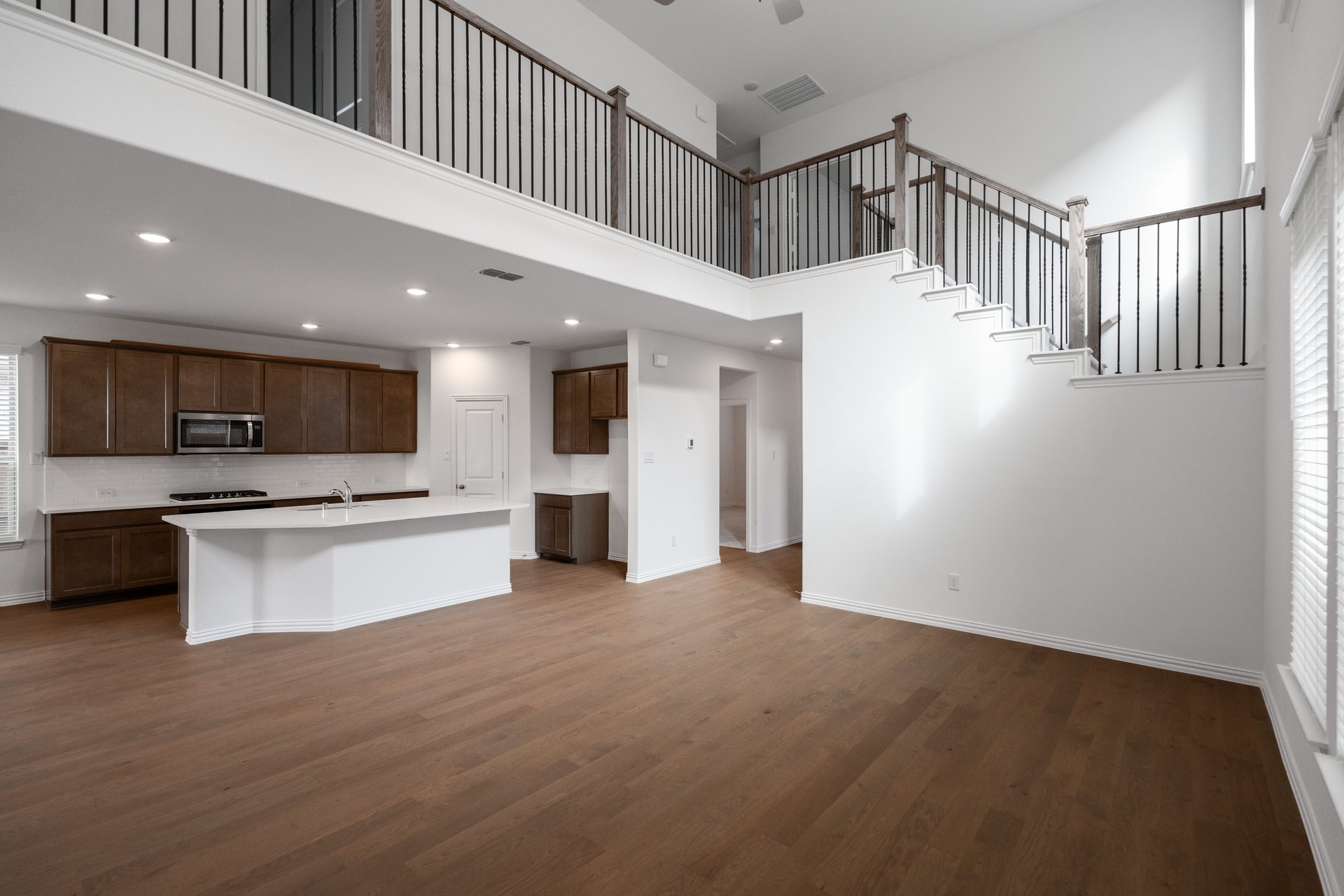 open great room with wood floors and tall ceilings