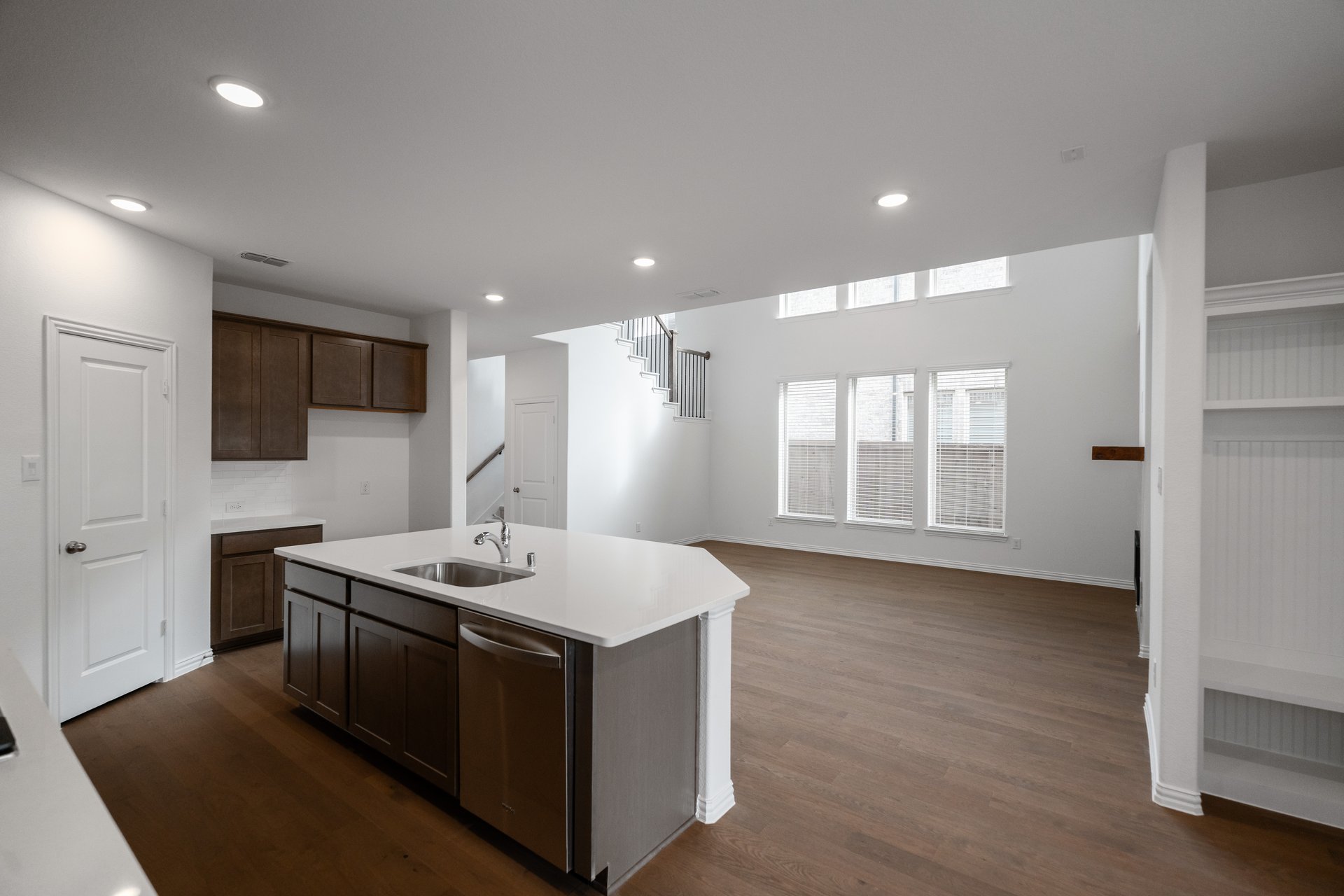 open kitchen with wood floors and island