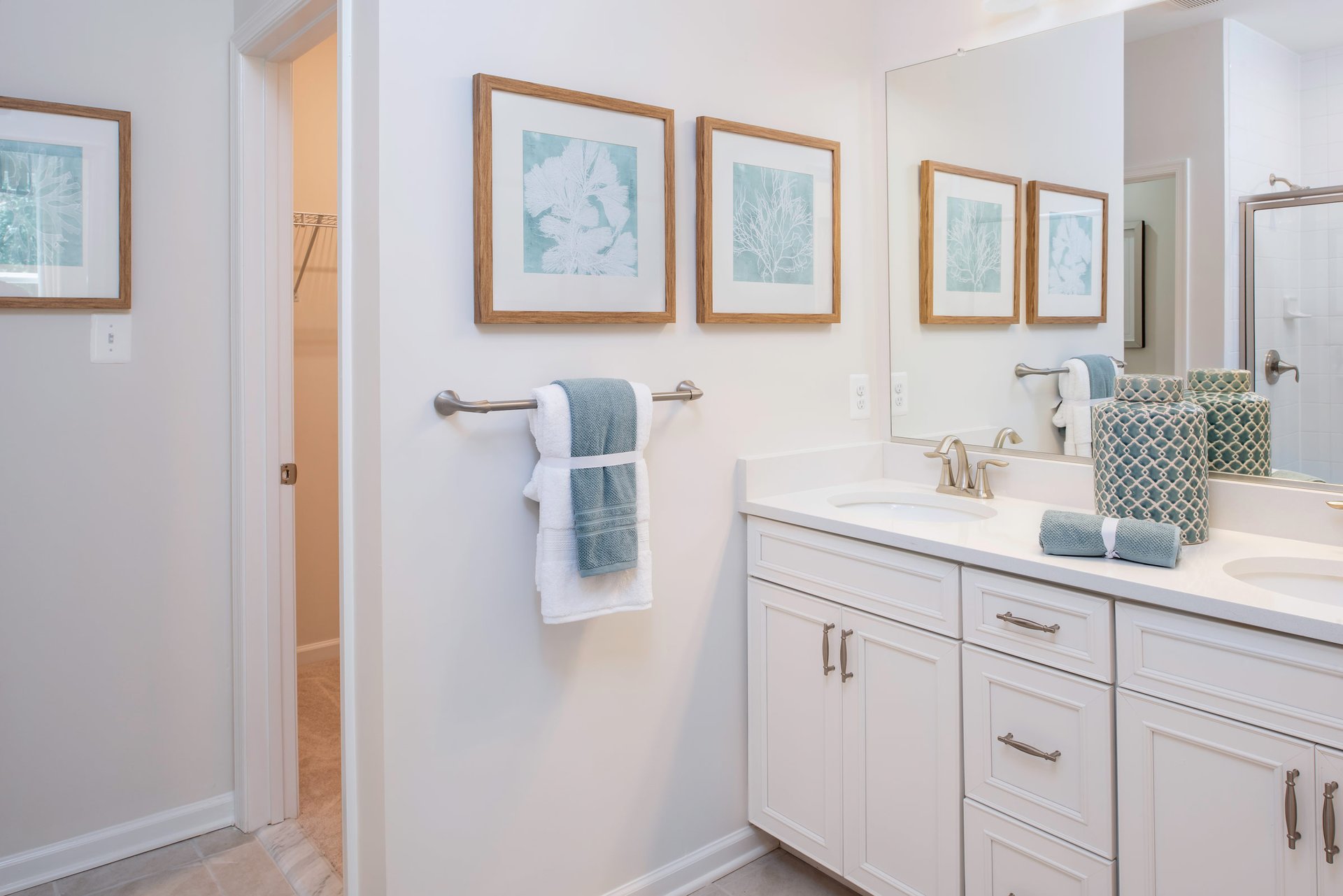 primary bath with white vanities