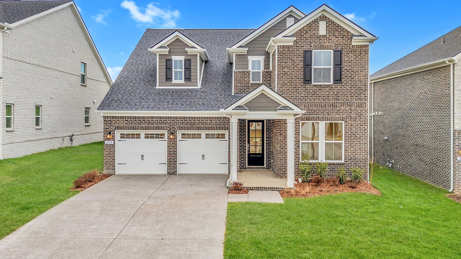 exterior with brick and a covered front porch