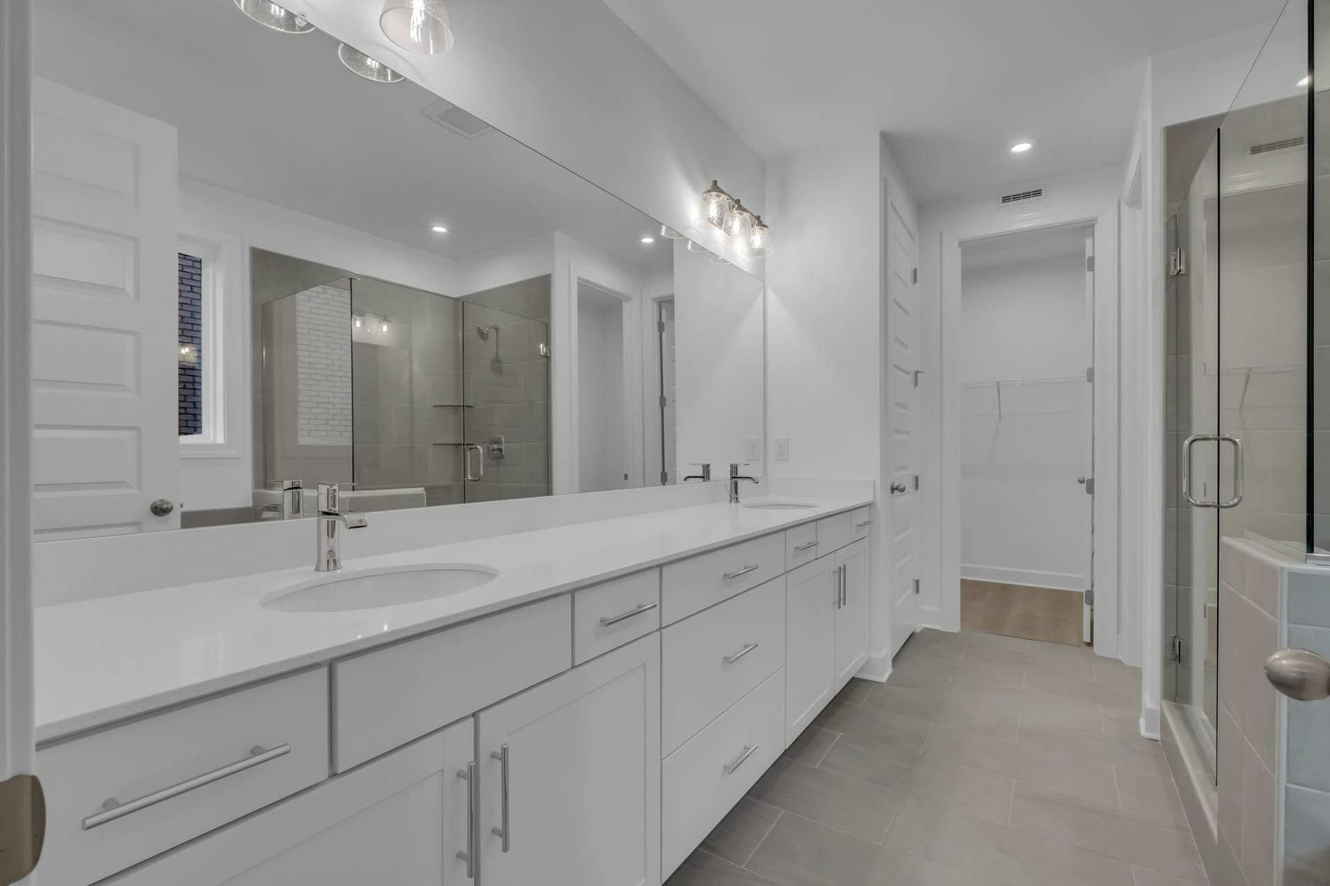 primary bathroom with double sink vanity, walk in shower, and a soaking tub