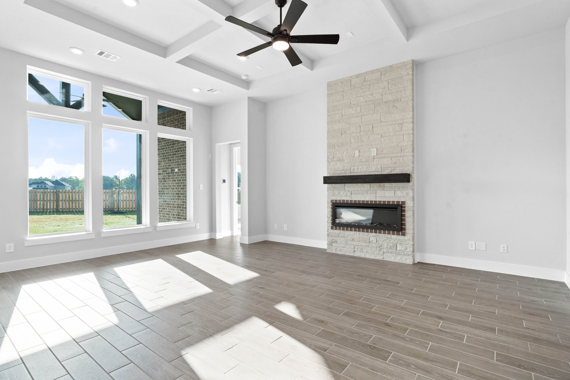 open great room with coffered ceiling