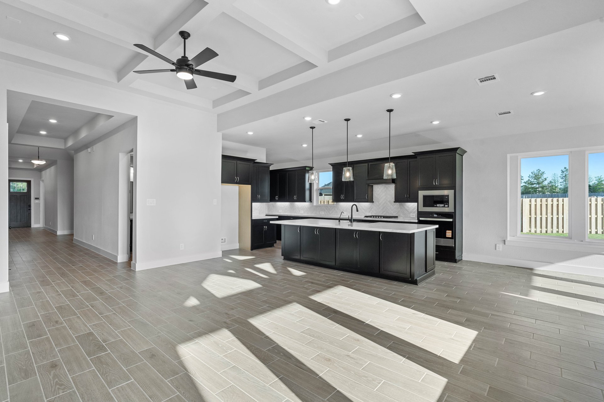 open kitchen with black cabinets and white countertops