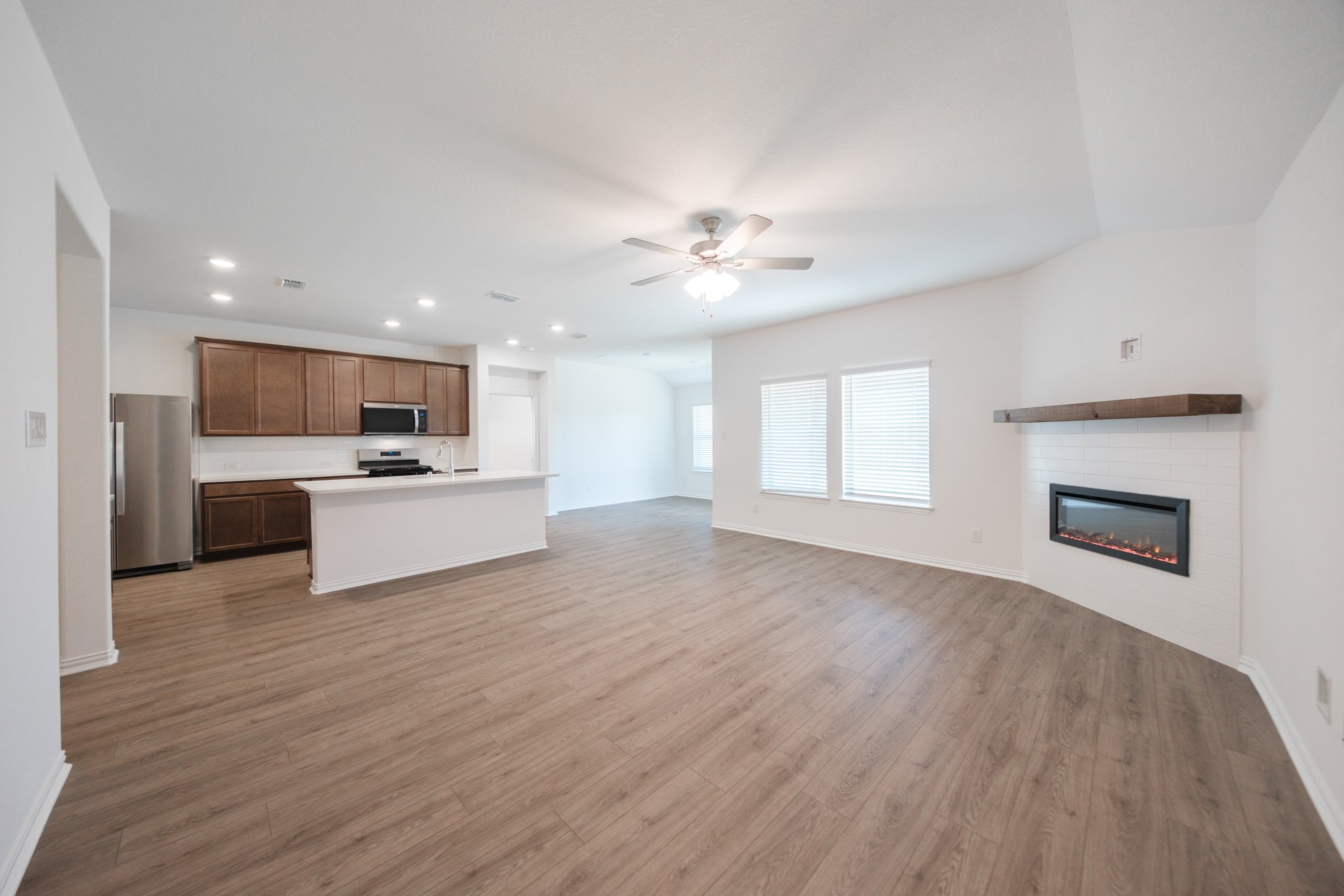 open great room with wood floors and fireplace