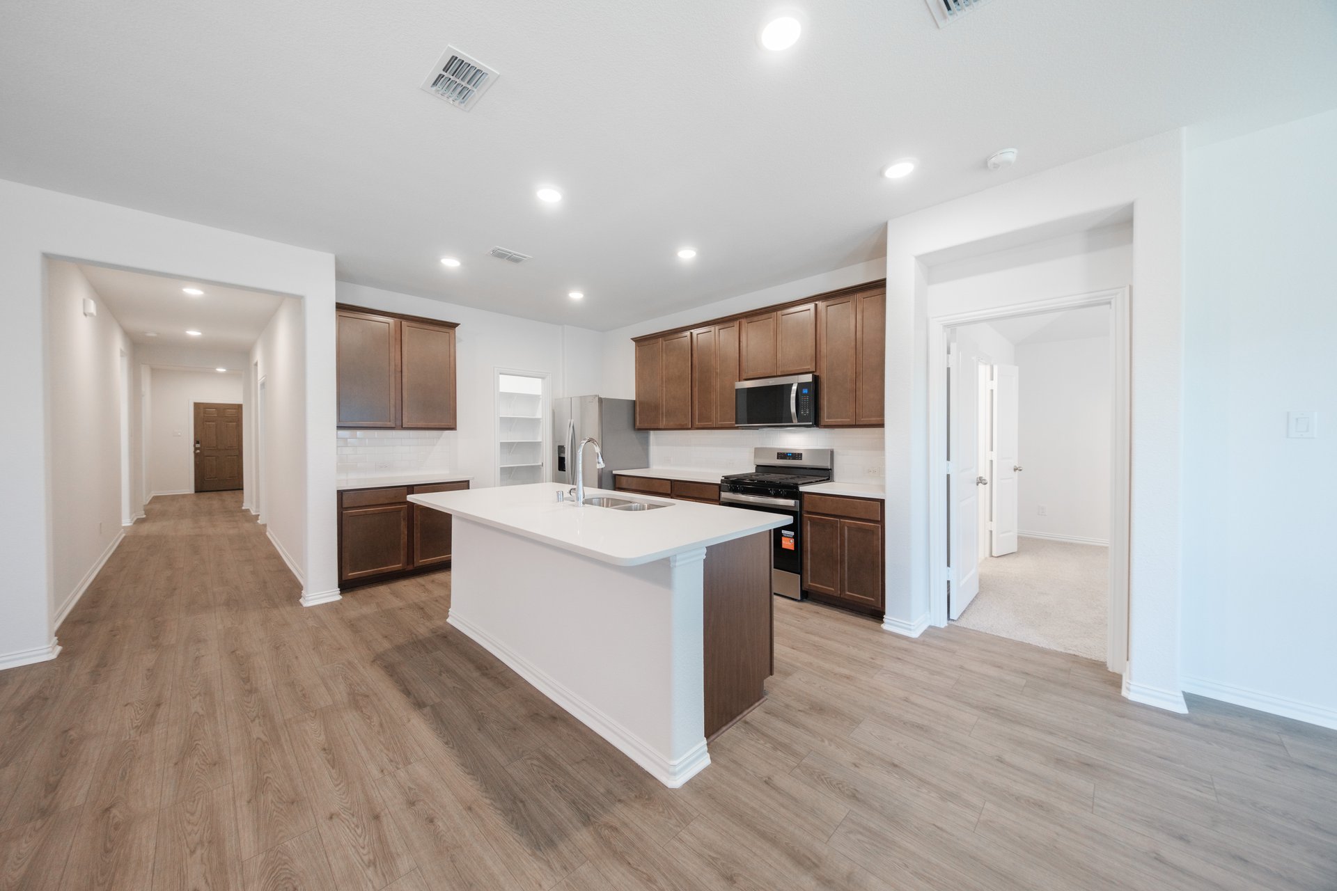 open kitchen with wood floors and island