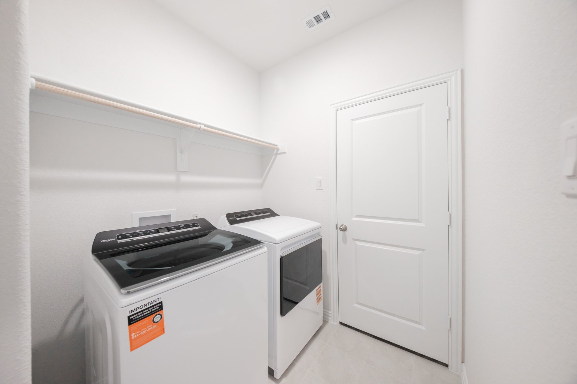 laundry room with tile floors, washer, and dryer