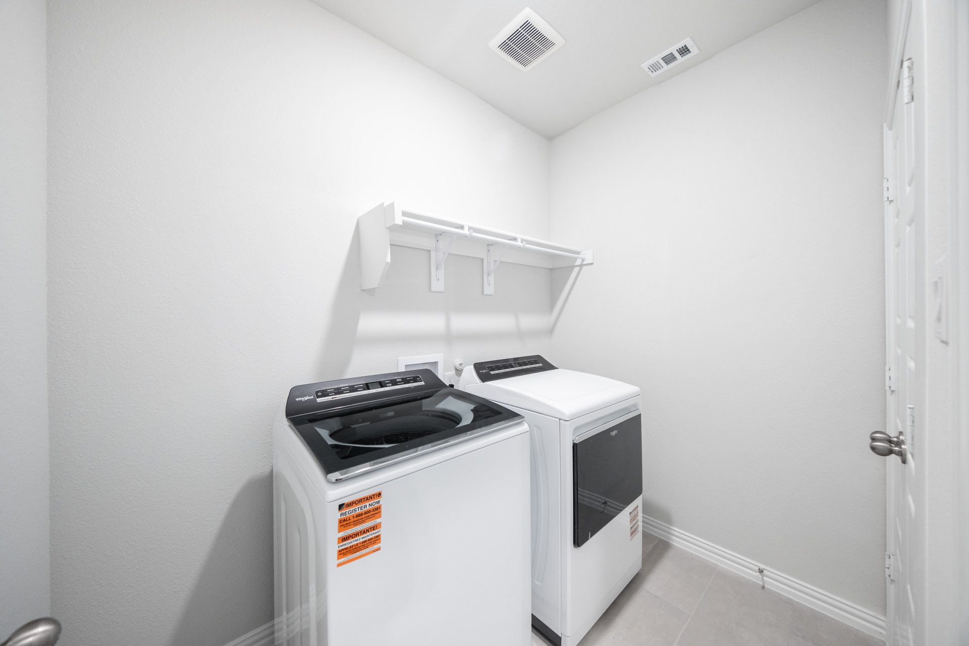 laundry room with washer, dryer, and tile floors