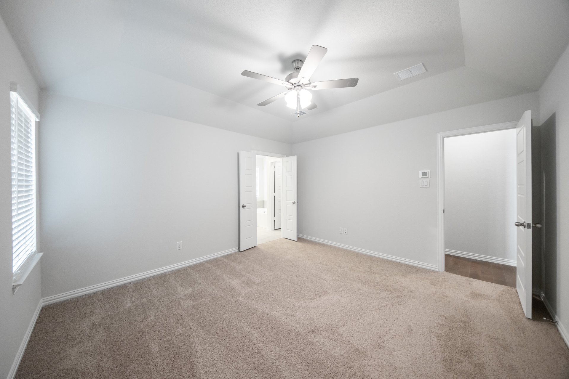 primary bedroom with carpet and window