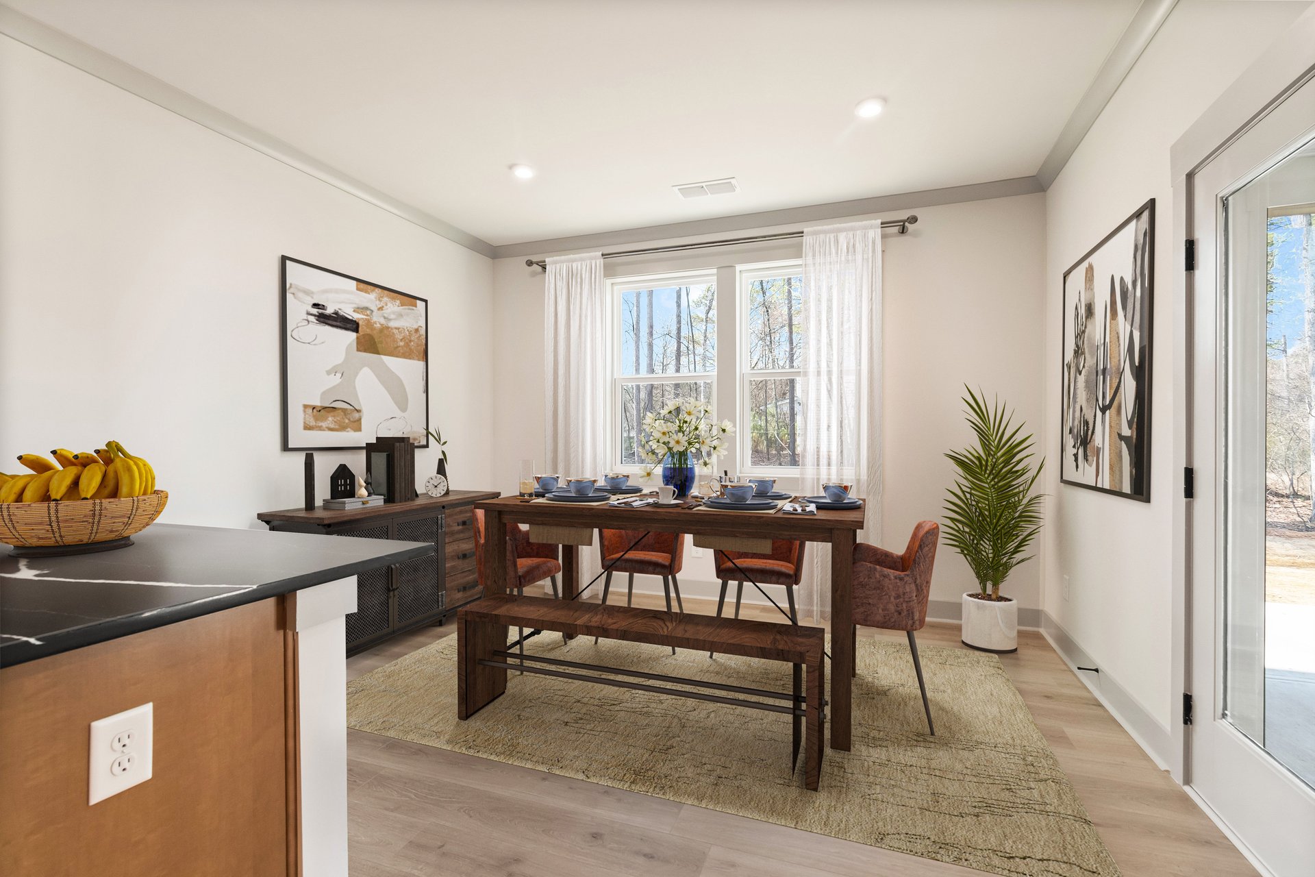 dining room with hard-surface flooring and door leading to patio