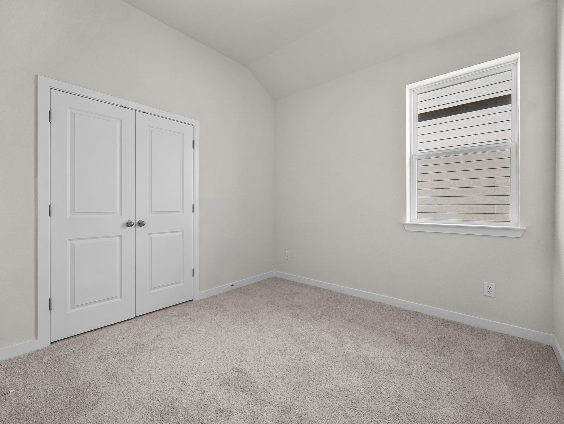bedroom with carpet, sloped ceiling & a window