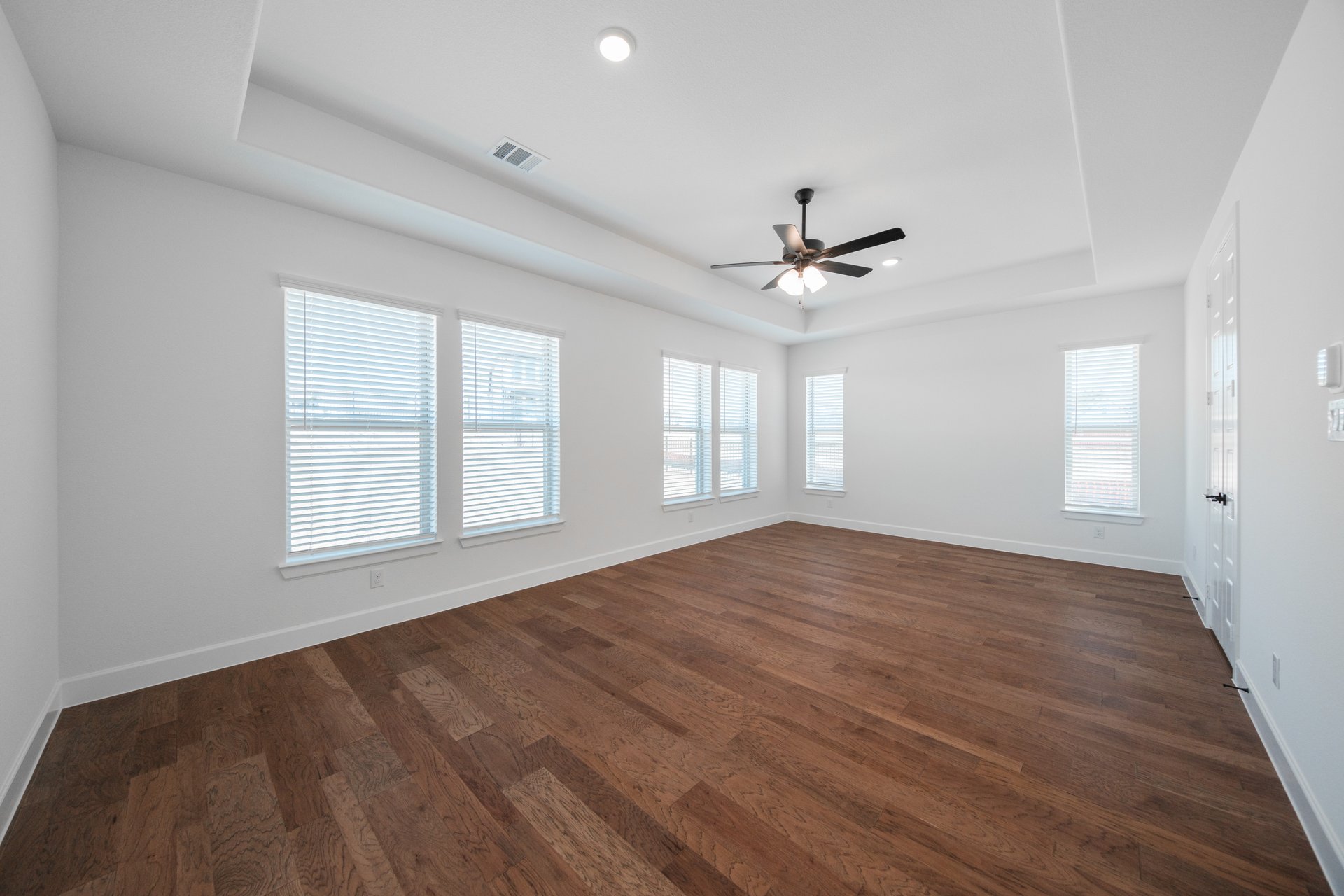 primary bedroom with hardwood flooring