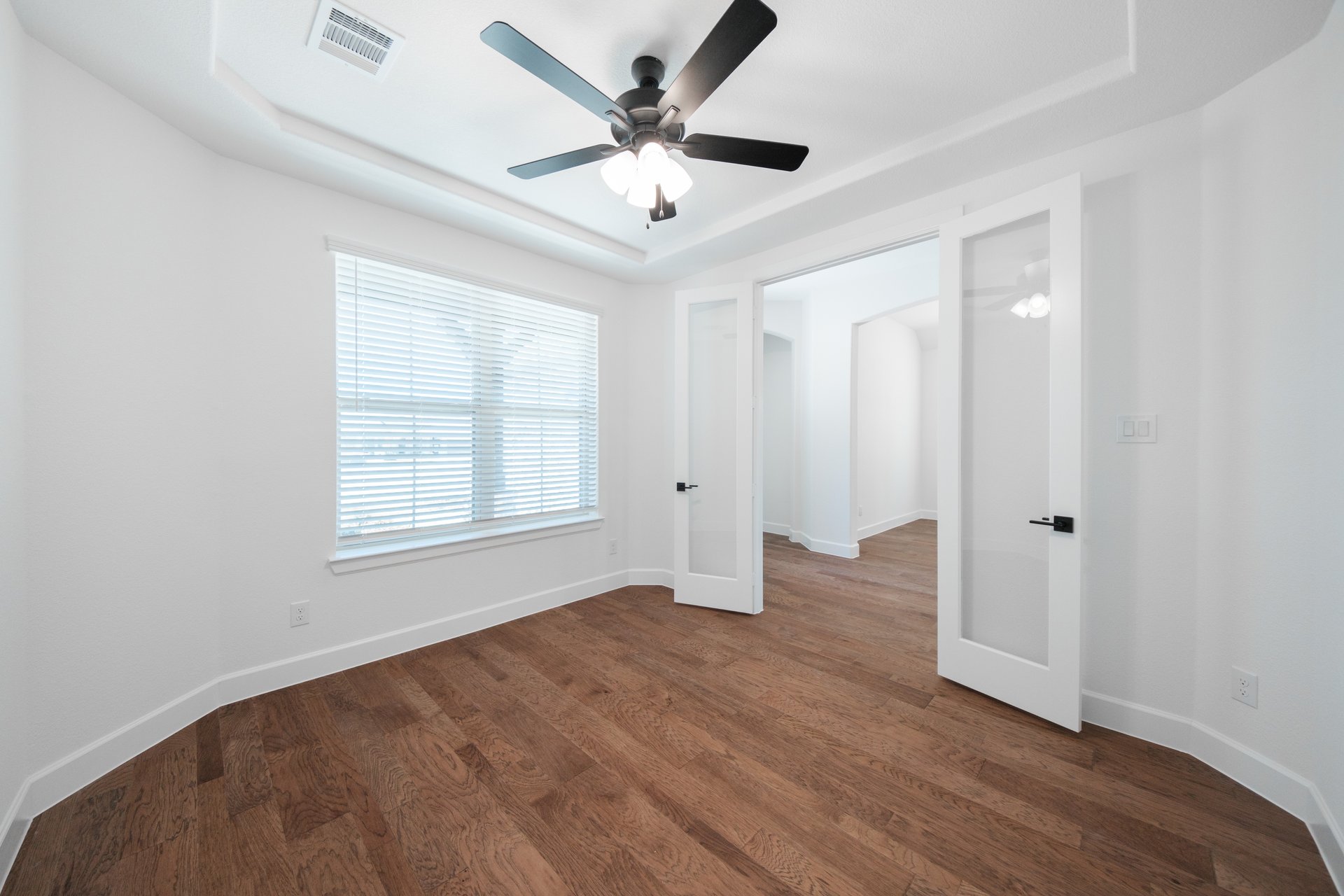 spacious study with hardwood flooring