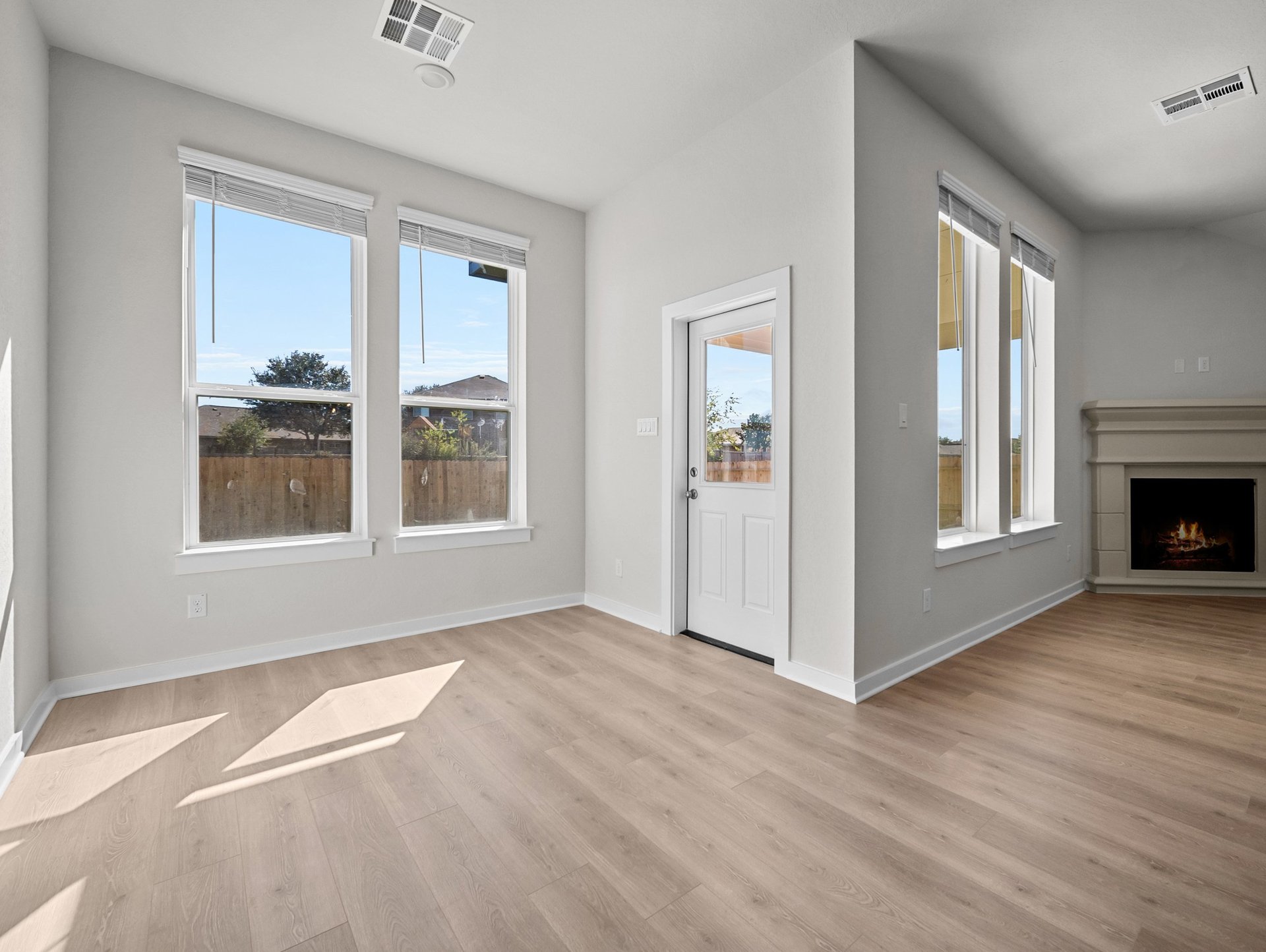 dining area with brown flooring, windows & recessed lighting