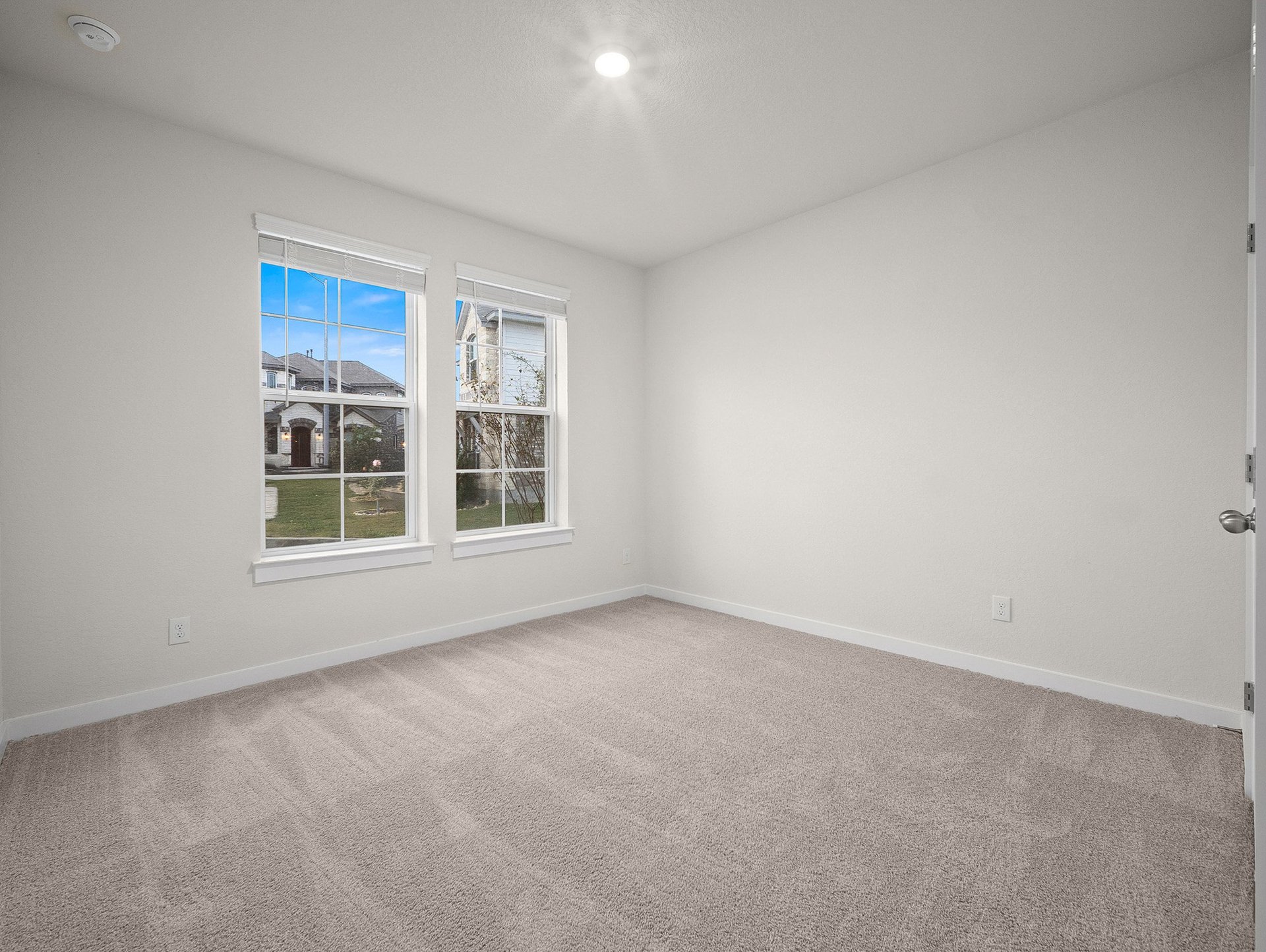 bedroom with carpet, windows & a sloped ceiling
