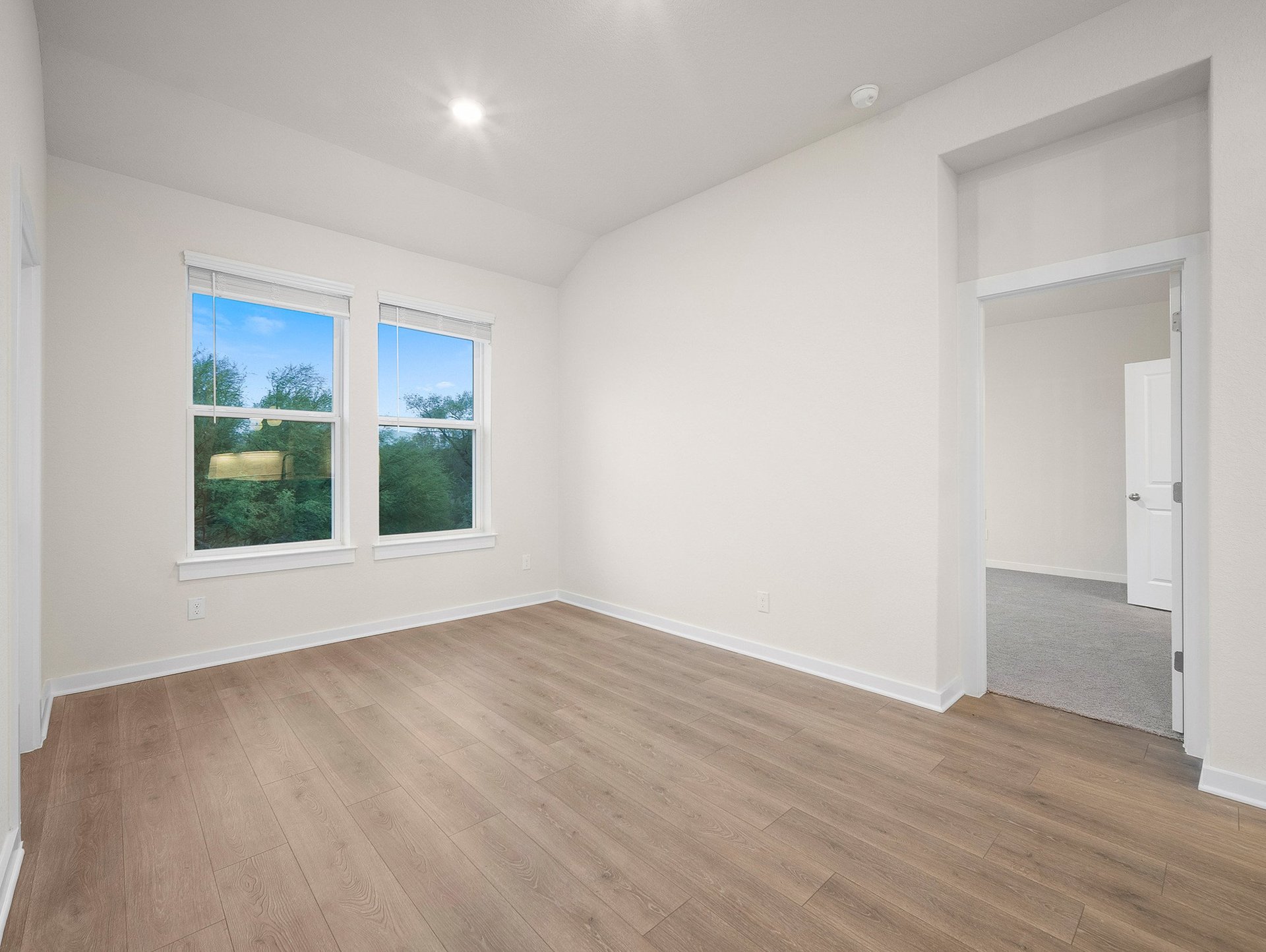 dining area with a window, brown flooring & recessed lighting