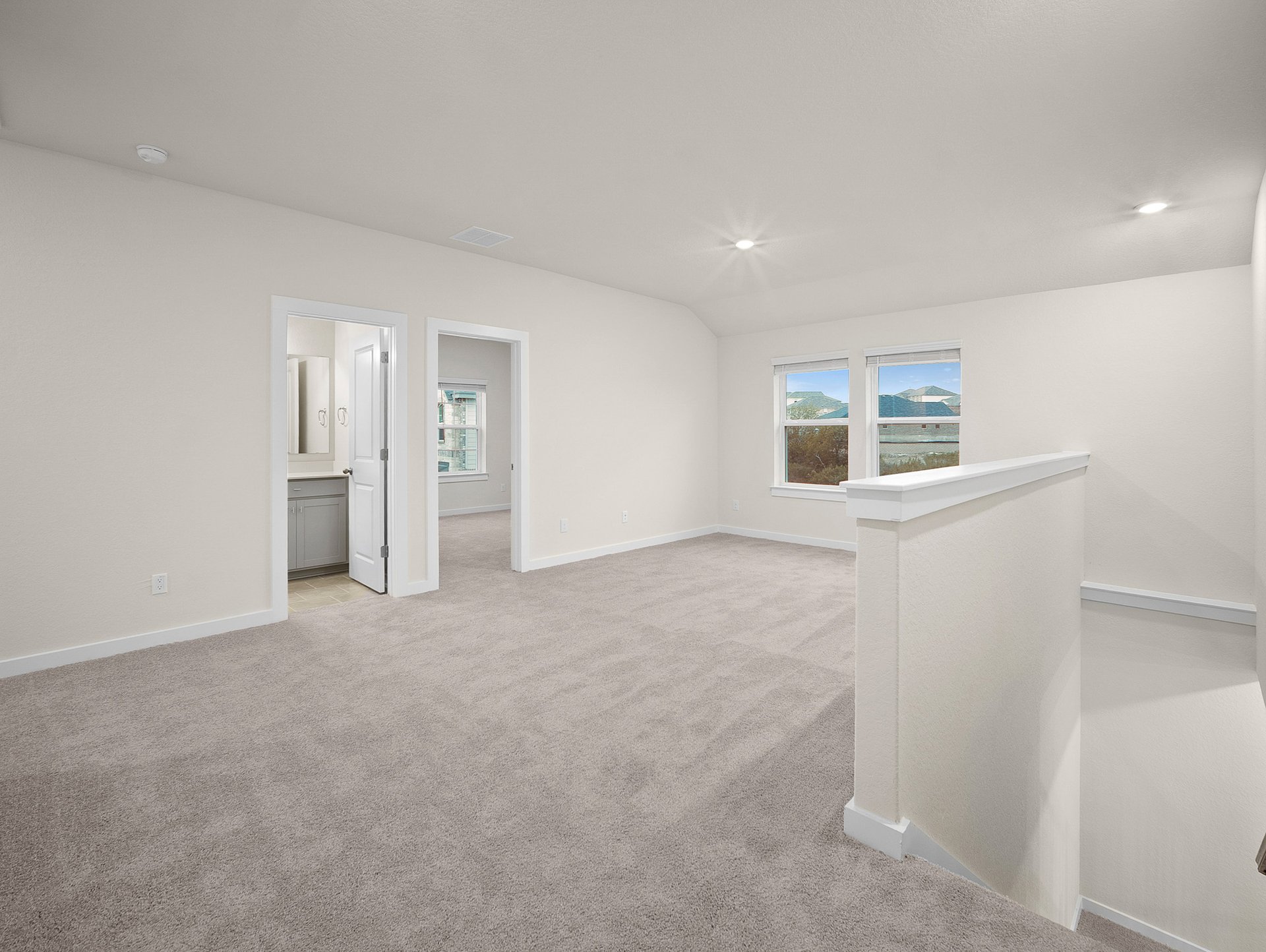 loft with carpet, windows & a sloped ceiling