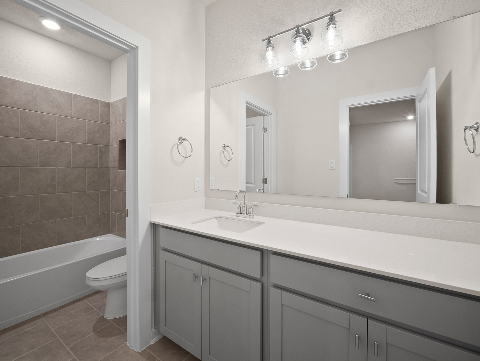 bathroom with quartz countertops & a bathtub