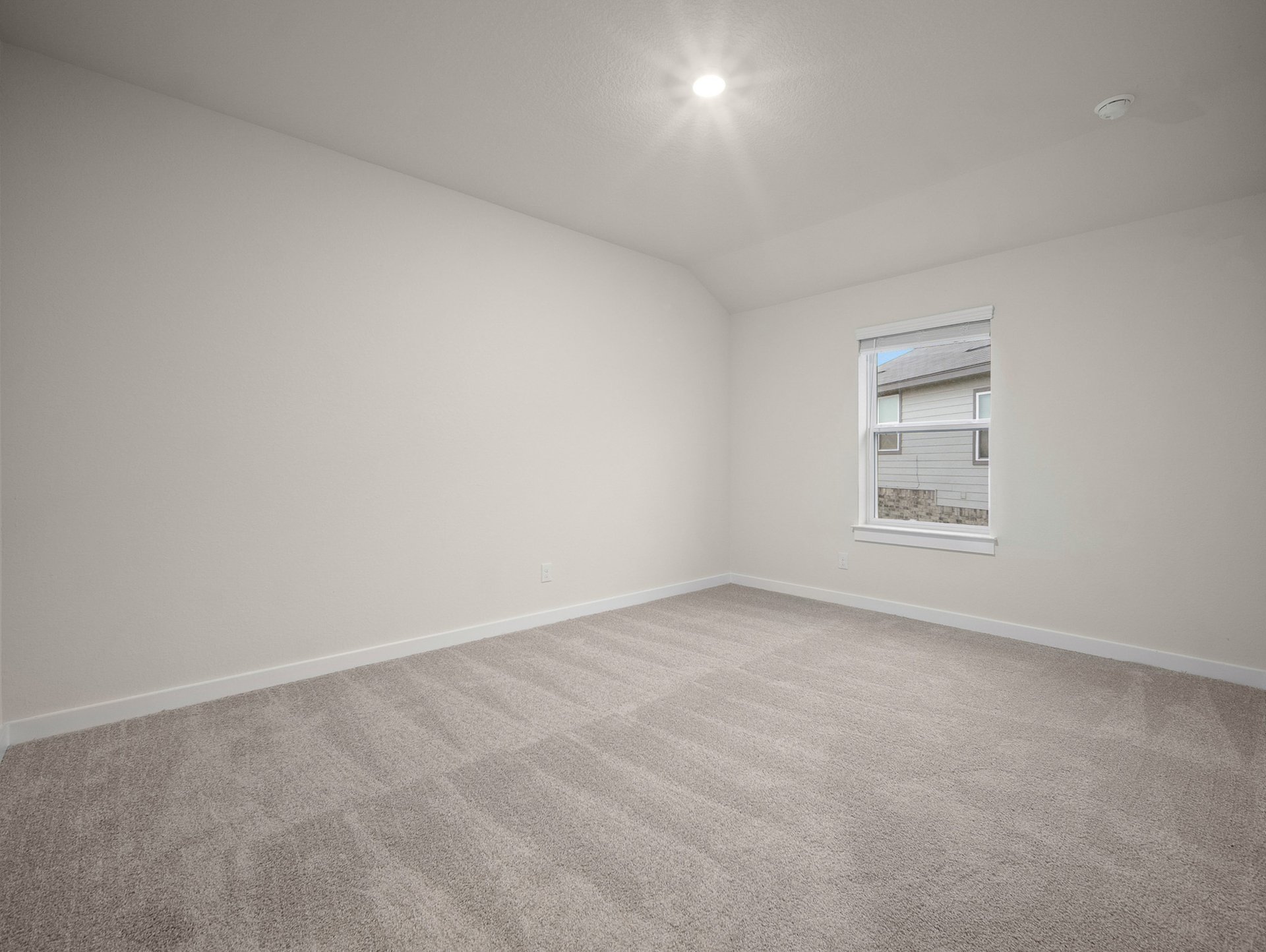 bedroom with carpet, window & a sloped ceiling