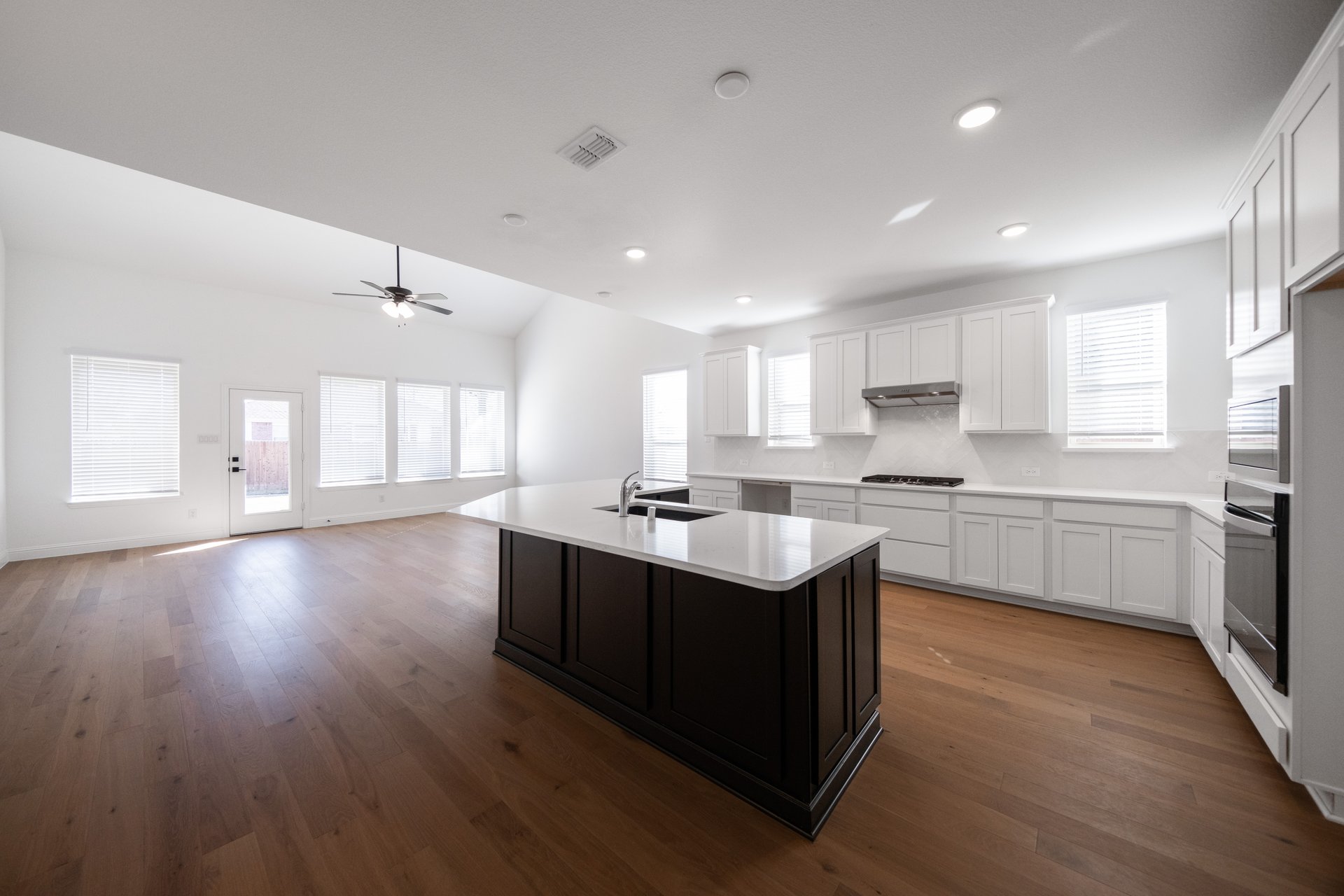 open kitchen with wood floors and island