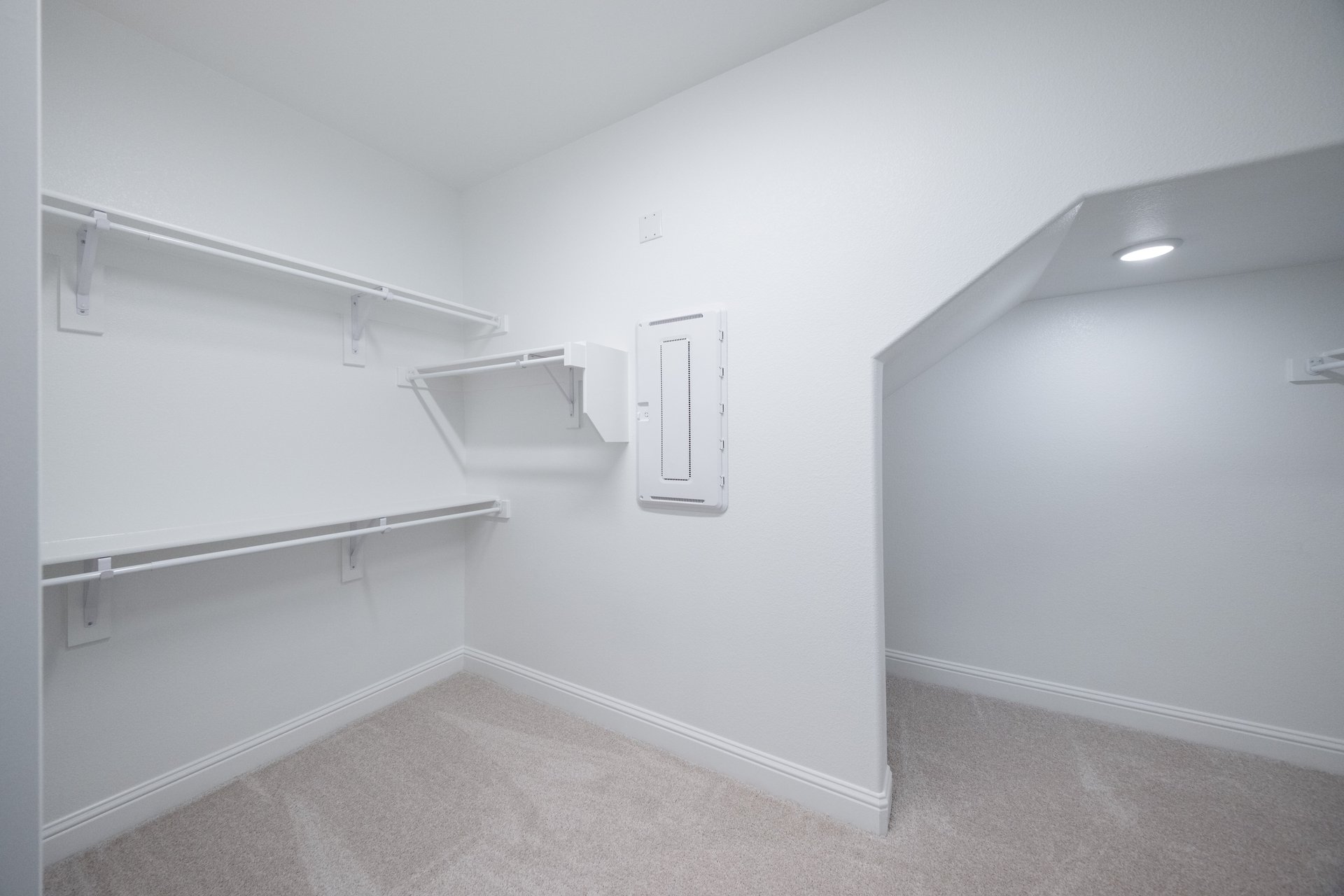 primary bedroom closet with carpet and white shelves