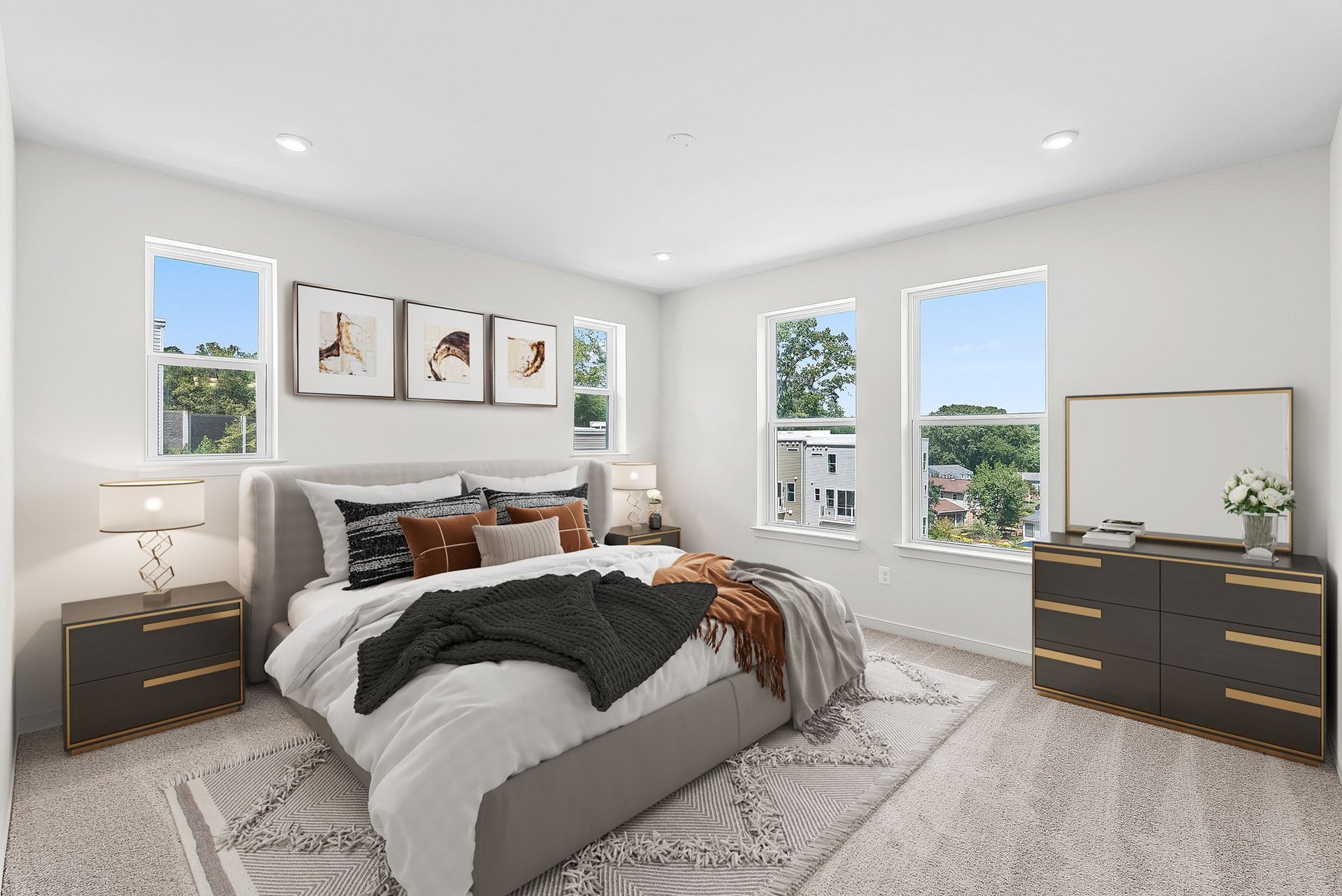 primary bedroom with multiple windows and carpet