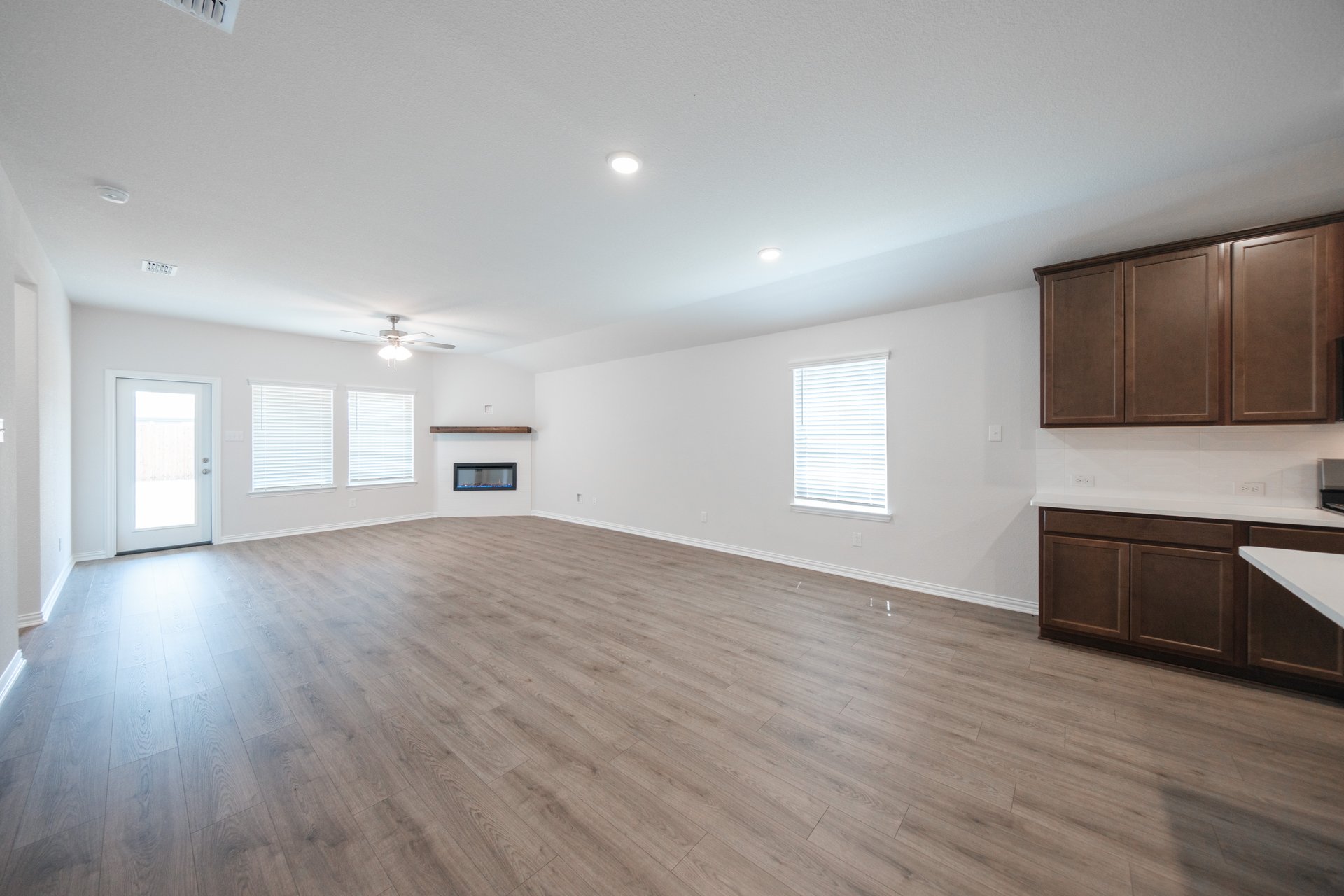 open great room with wood floors and fireplace