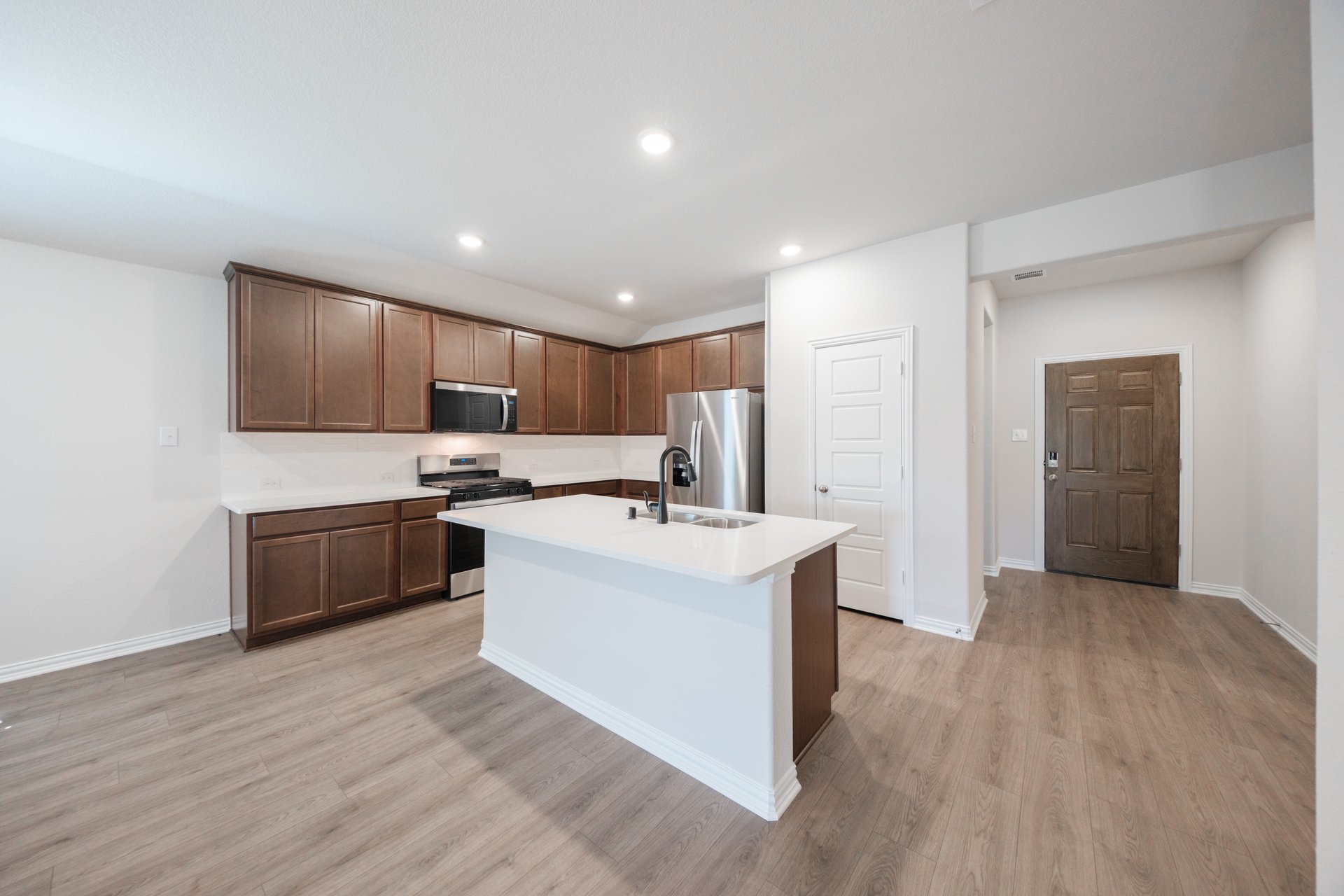 open kitchen with wood floors and island