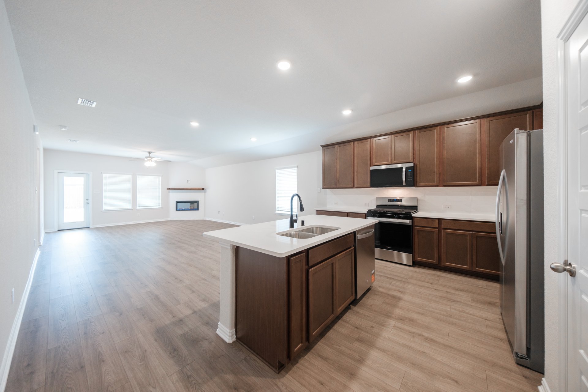 open kitchen with wood floors and island