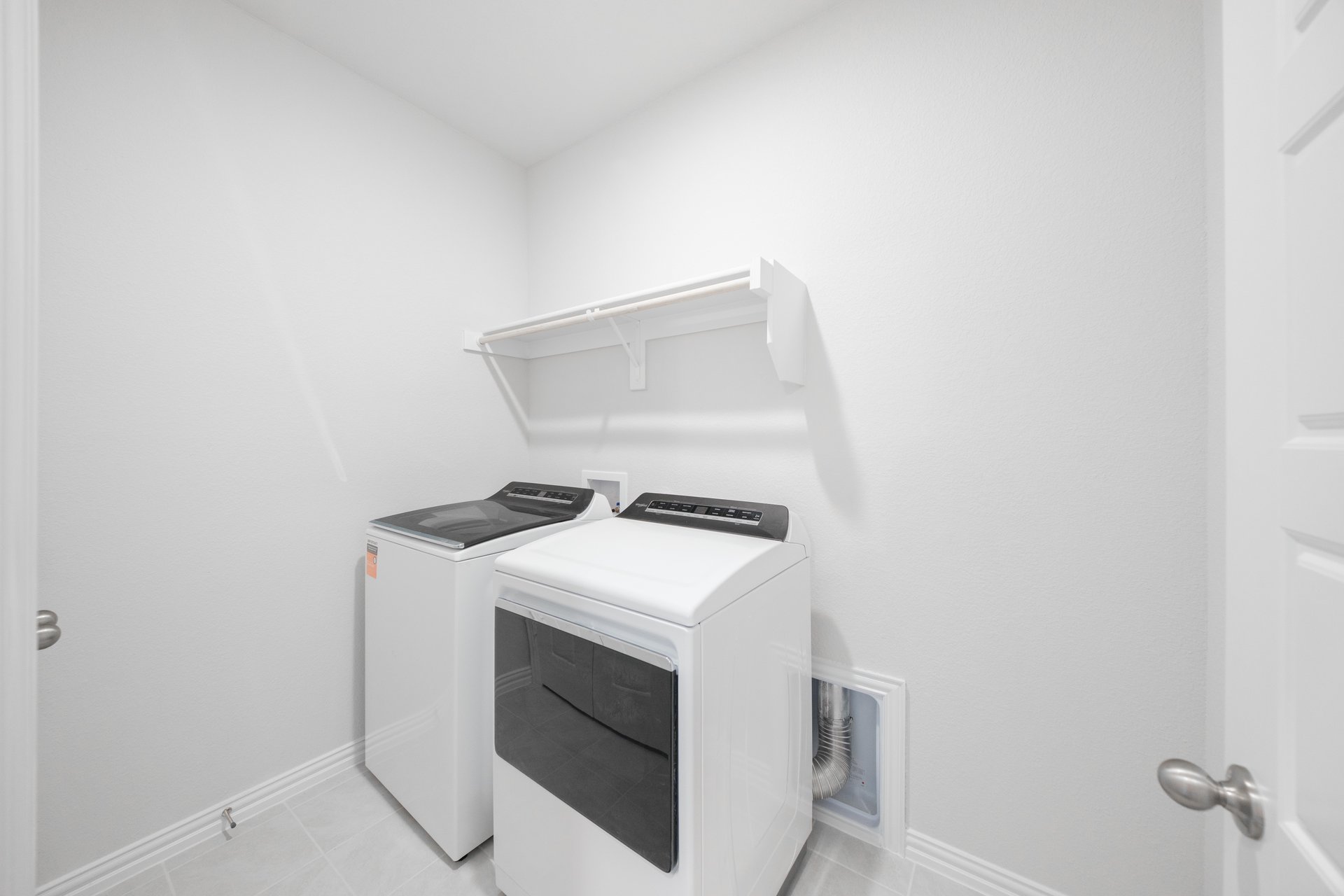 laundry room with tile floors, washer, and dryer