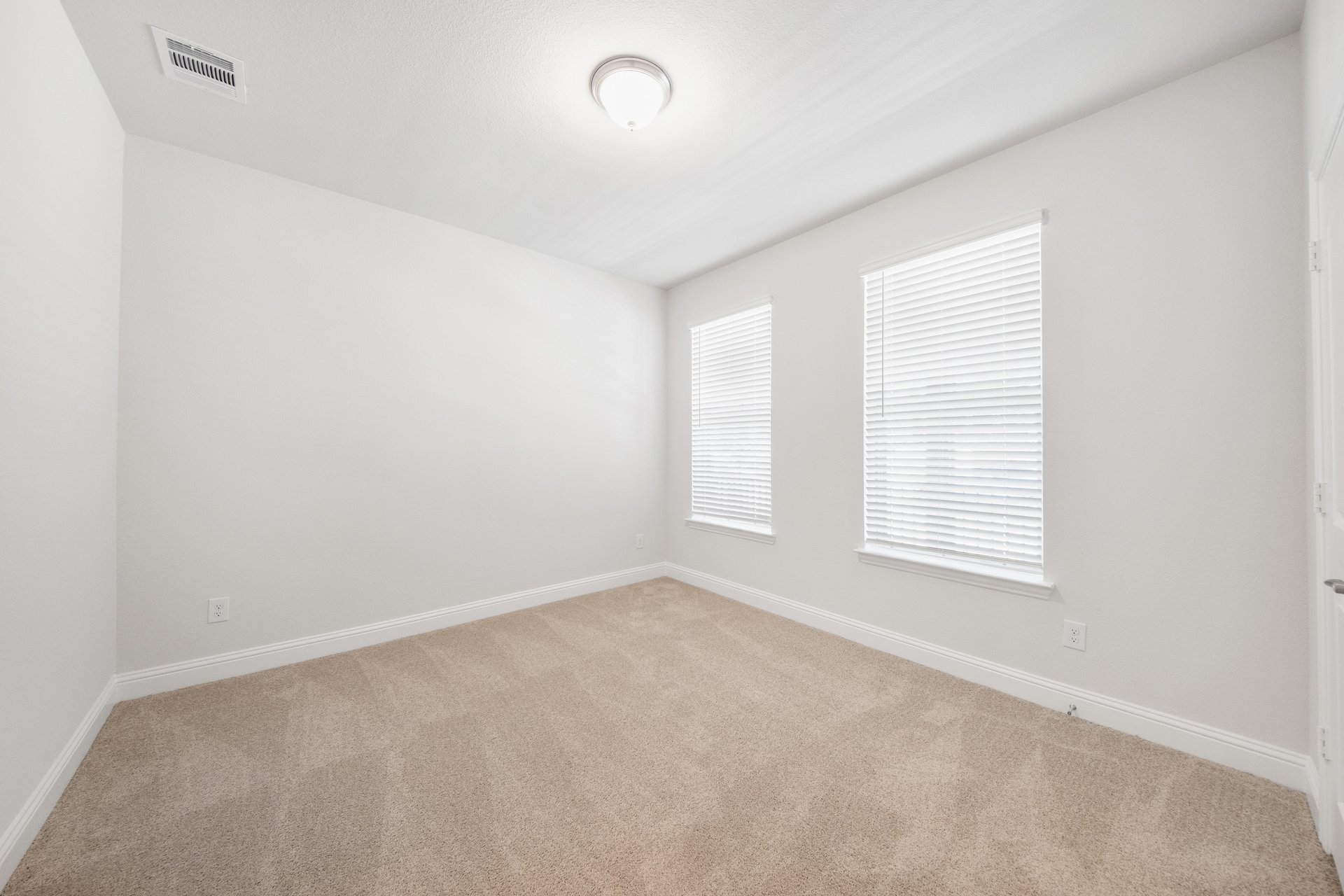 bedroom with carpet and windows