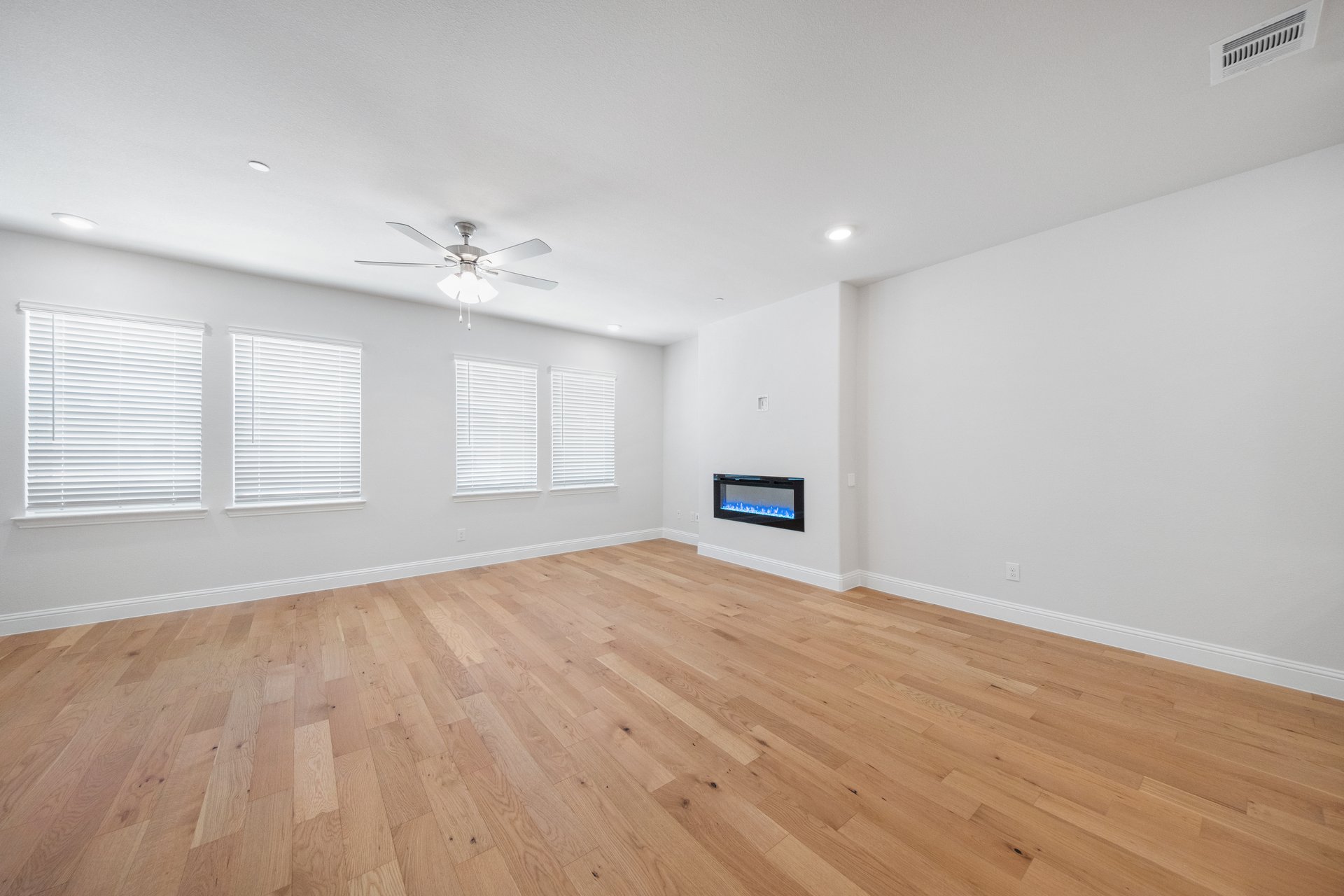 great room with wood floors and fireplace