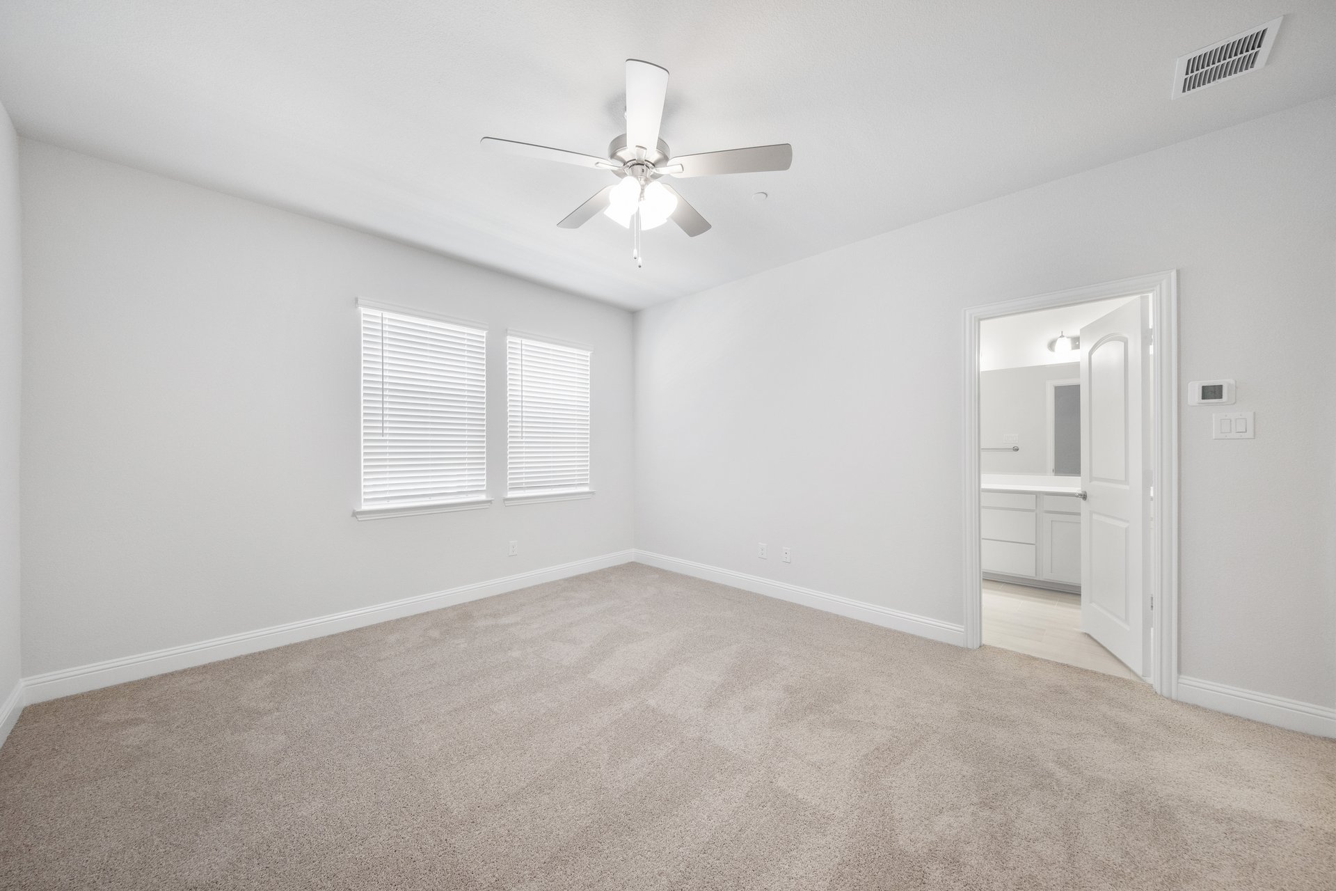 bedroom with carpet and windows