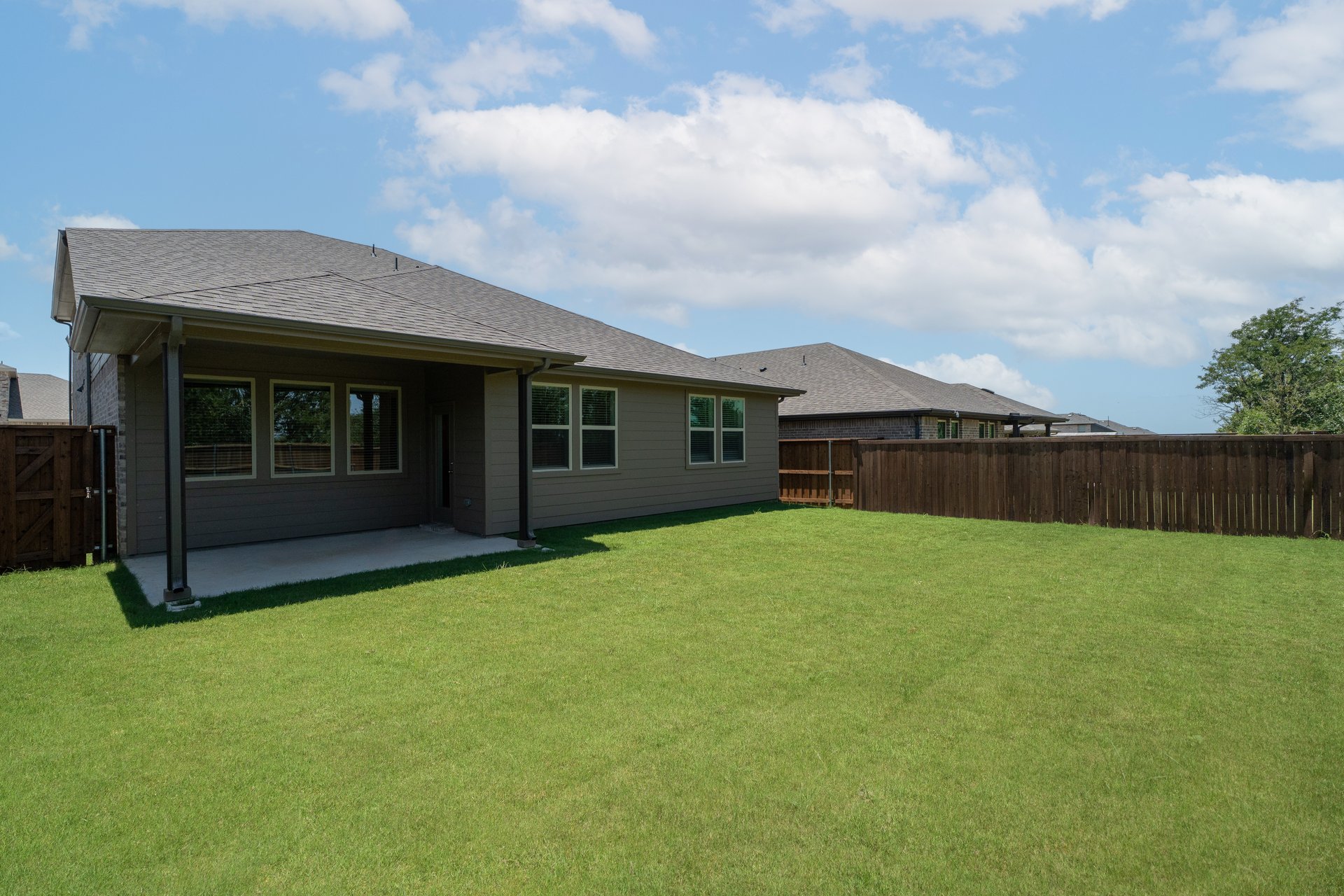 backyard with grass and covered patio