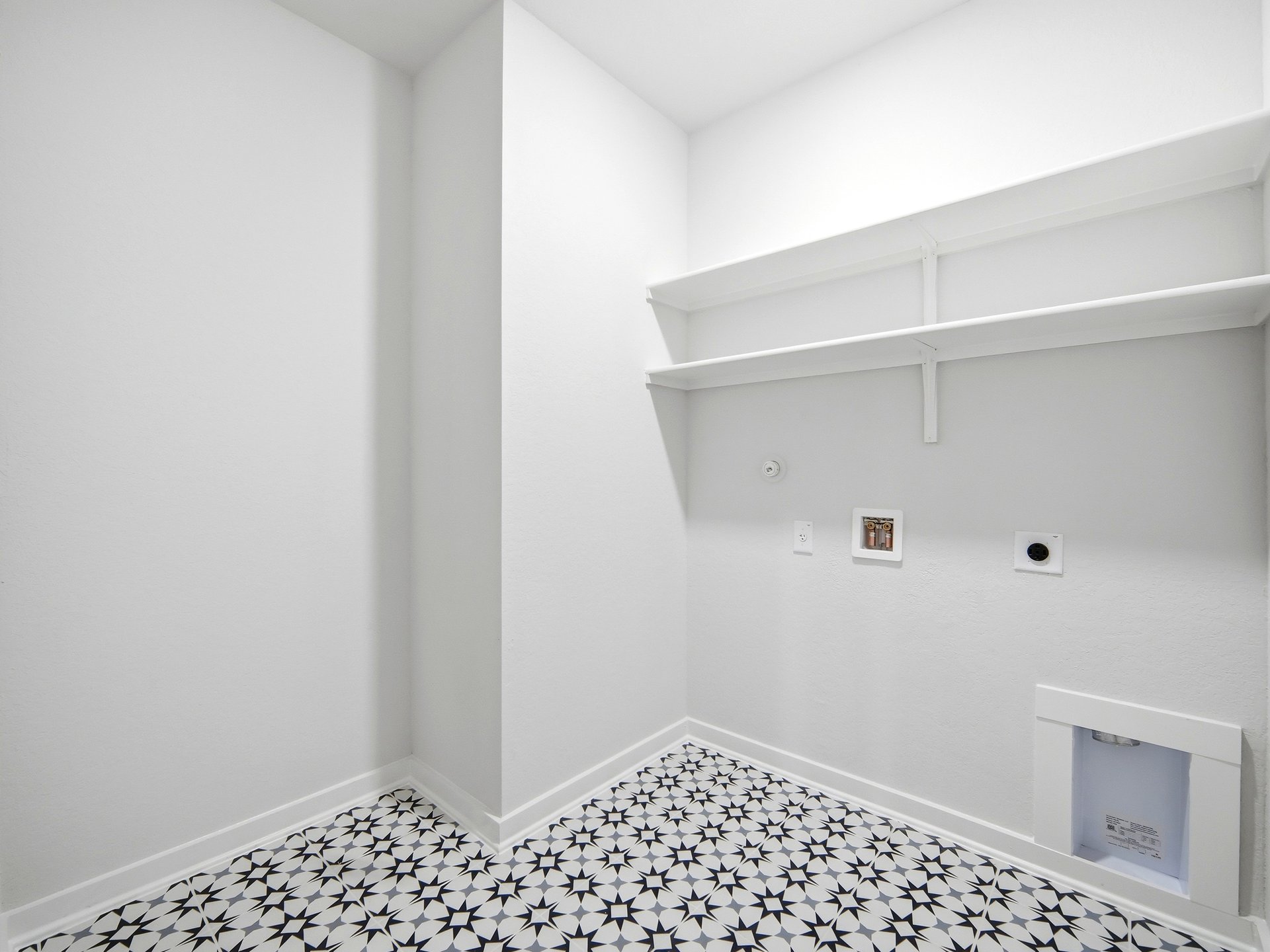 laundry room with white and black flooring