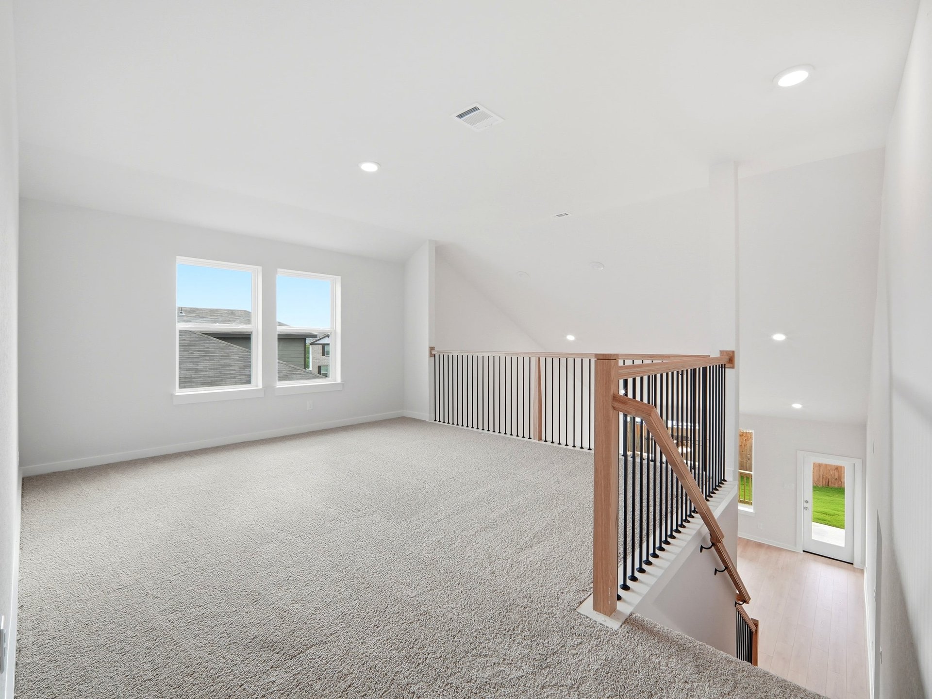 loft with carpet and dual windows