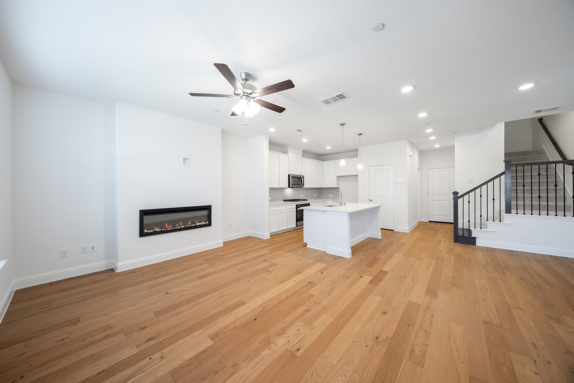 open great room with wood floors and fireplace