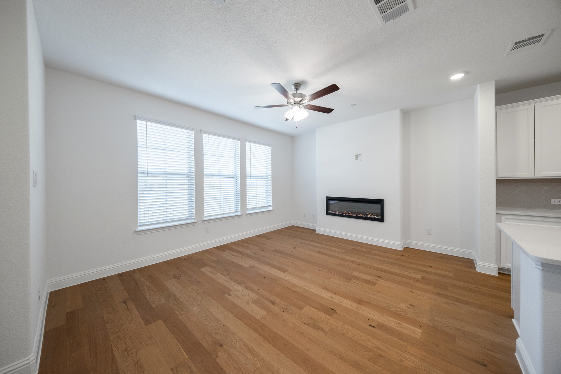 open great room with wood floors and fireplace