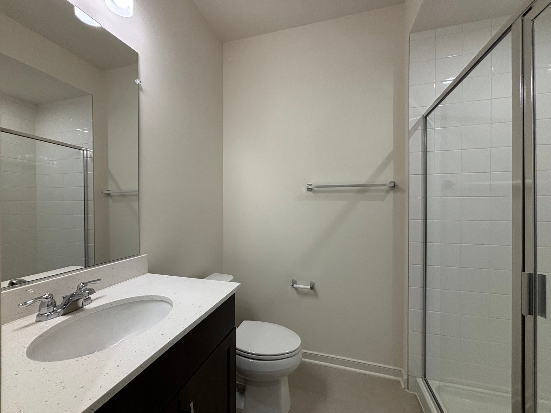 secondary bathroom with a walk-in shower