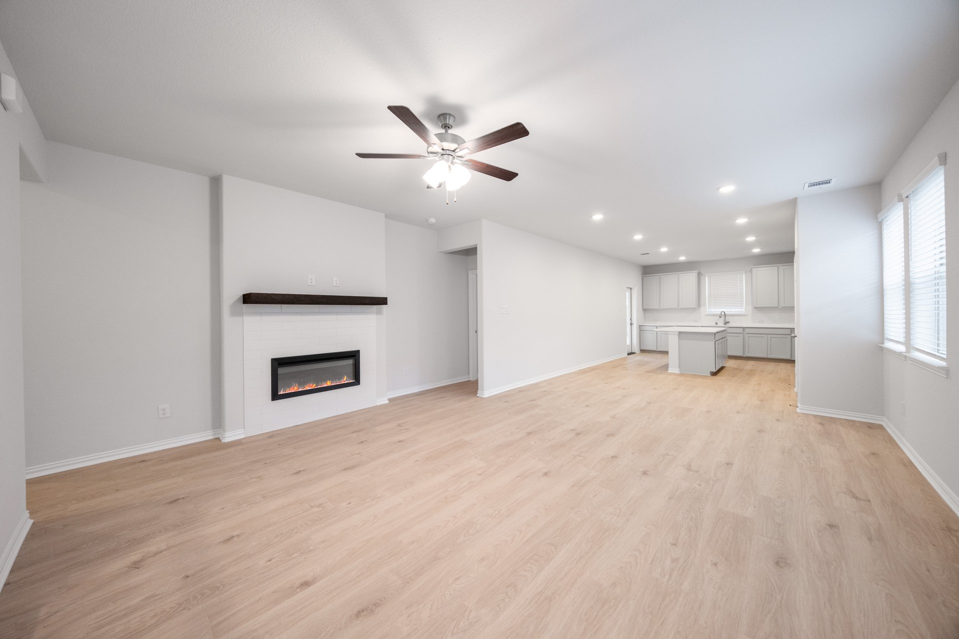 great room with wood flooring and fireplace