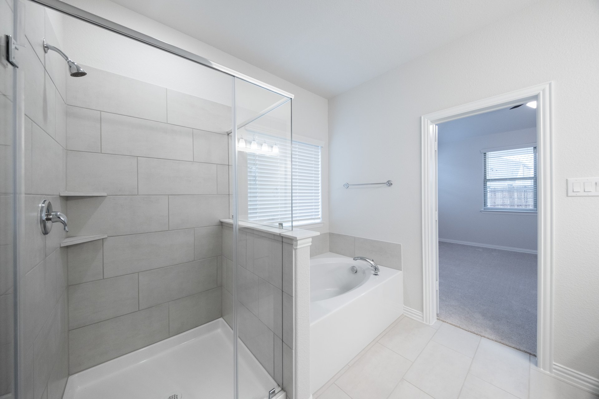 bathroom with walk-in shower and tub