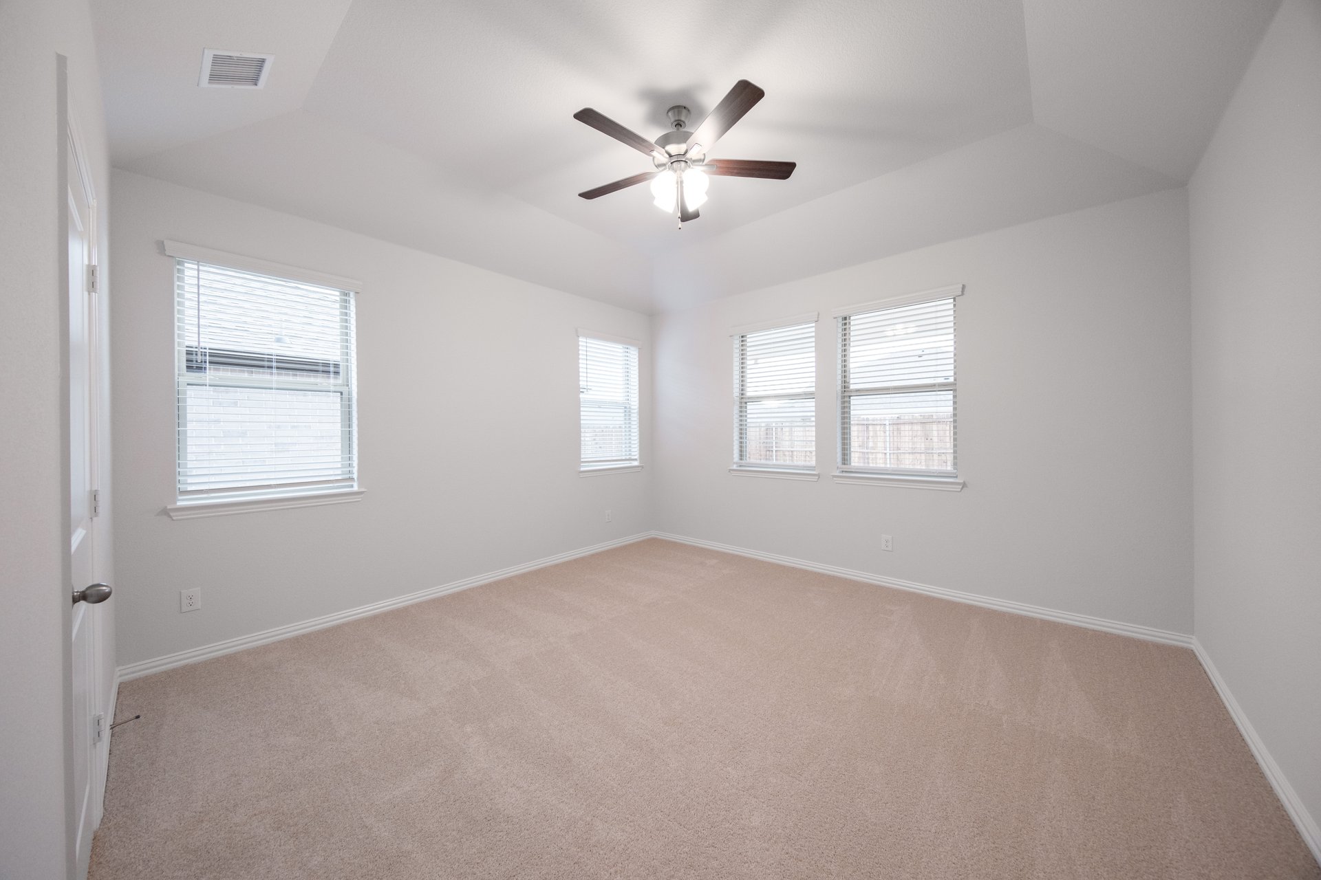 bedroom with windows with blinds