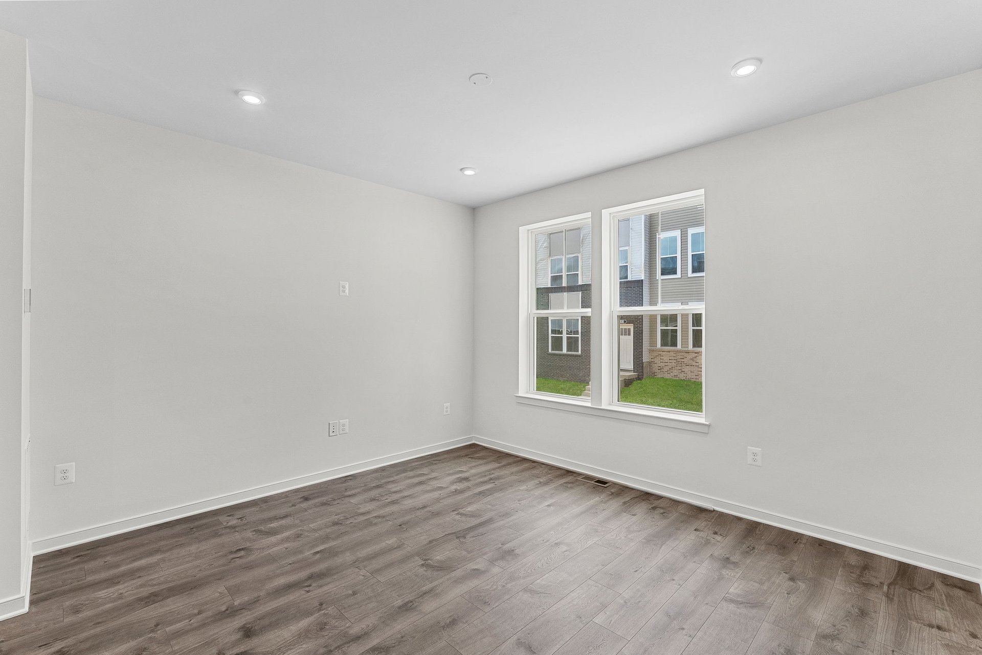 recreation room with solid flooring and windows