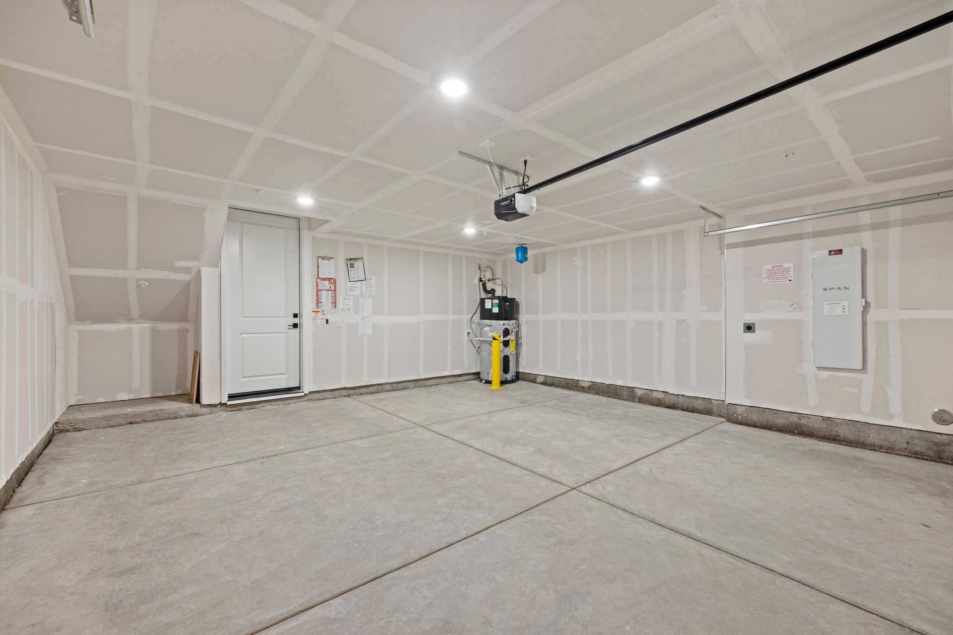 interior of spacious finished two-car garage with recessed ceiling lights