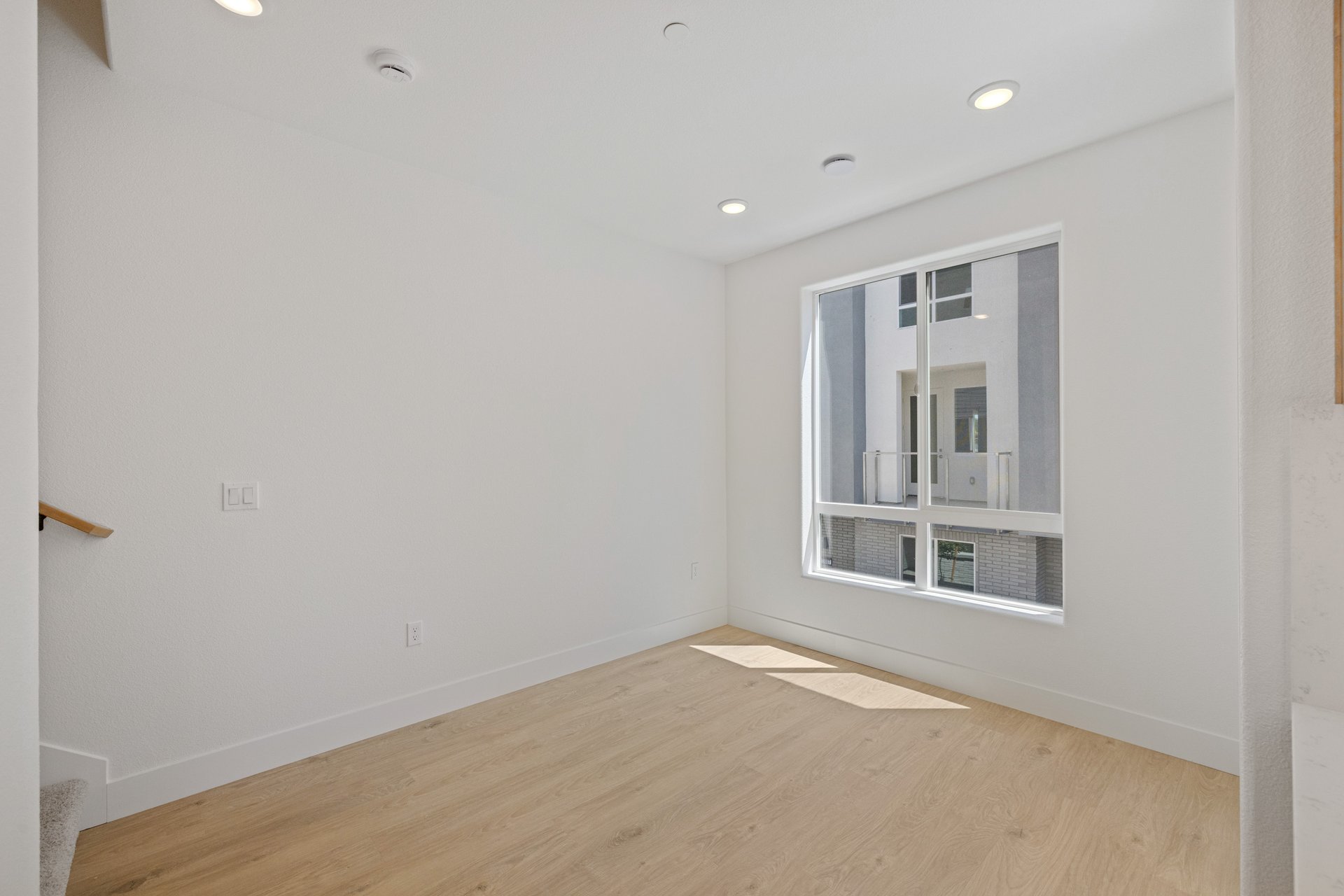 dining room with wood floors, white walls, and large window