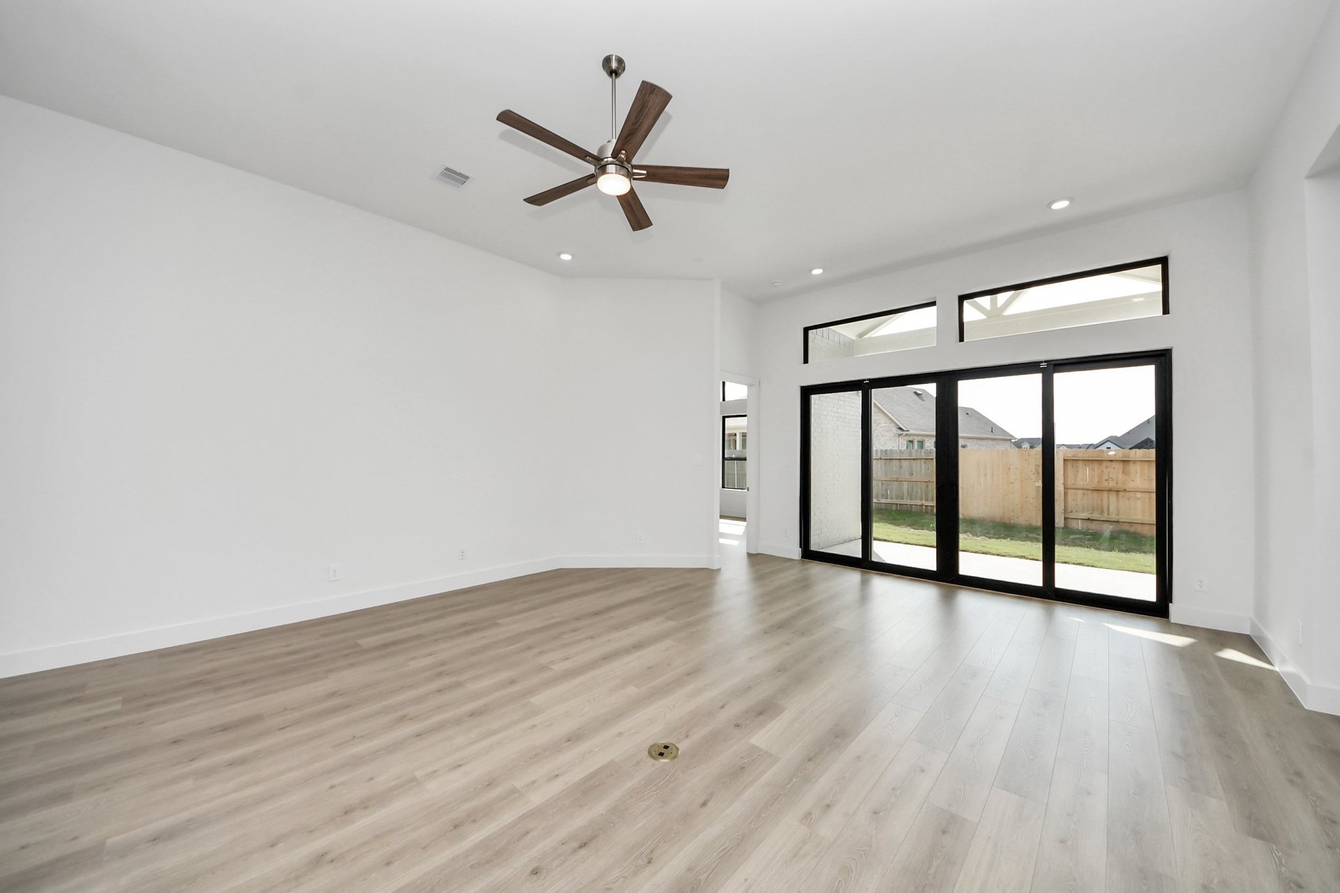 large sliding glass doors open to covered pack porch