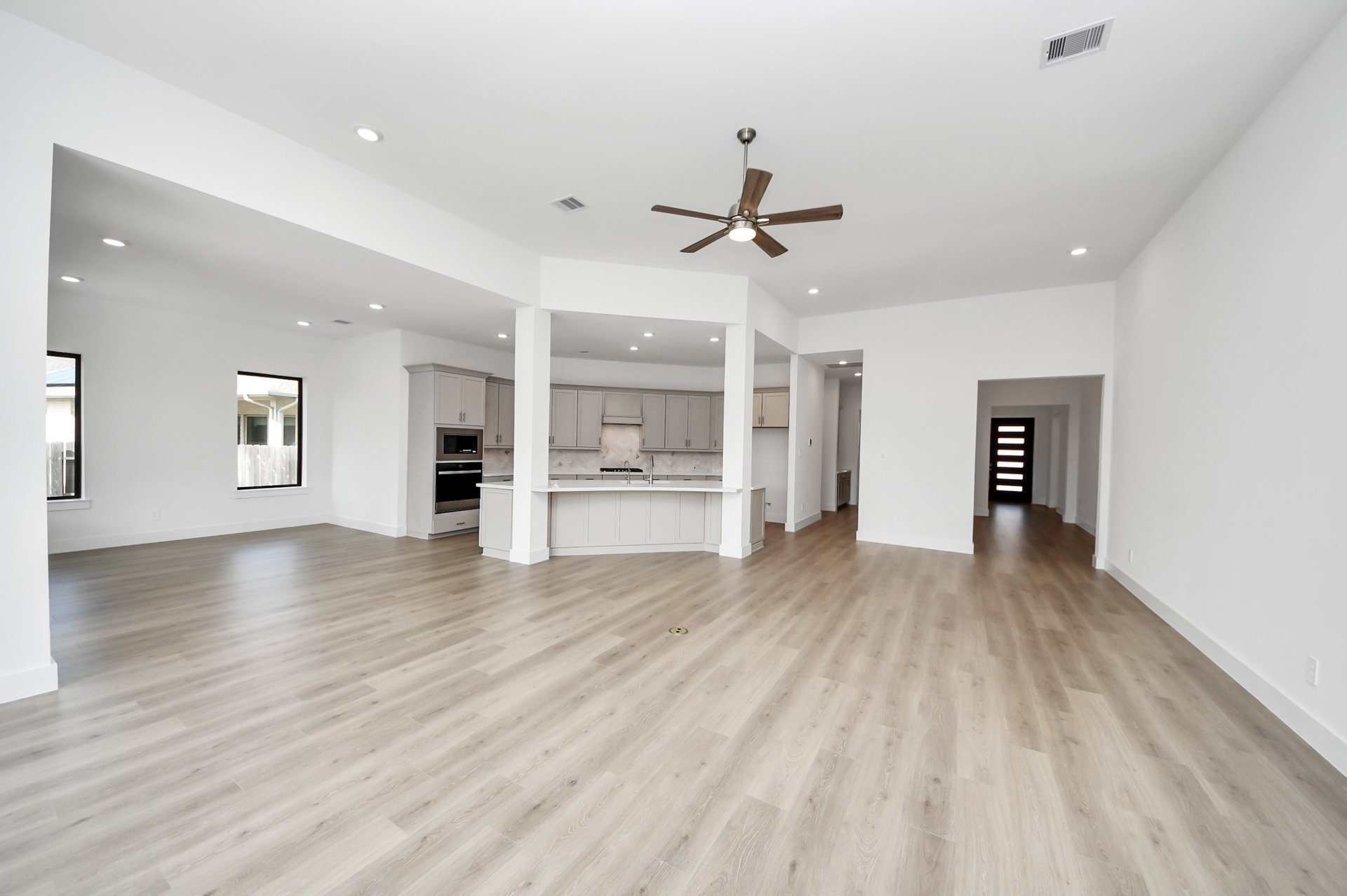 kitchen opens to large great room with continuous wood flooring