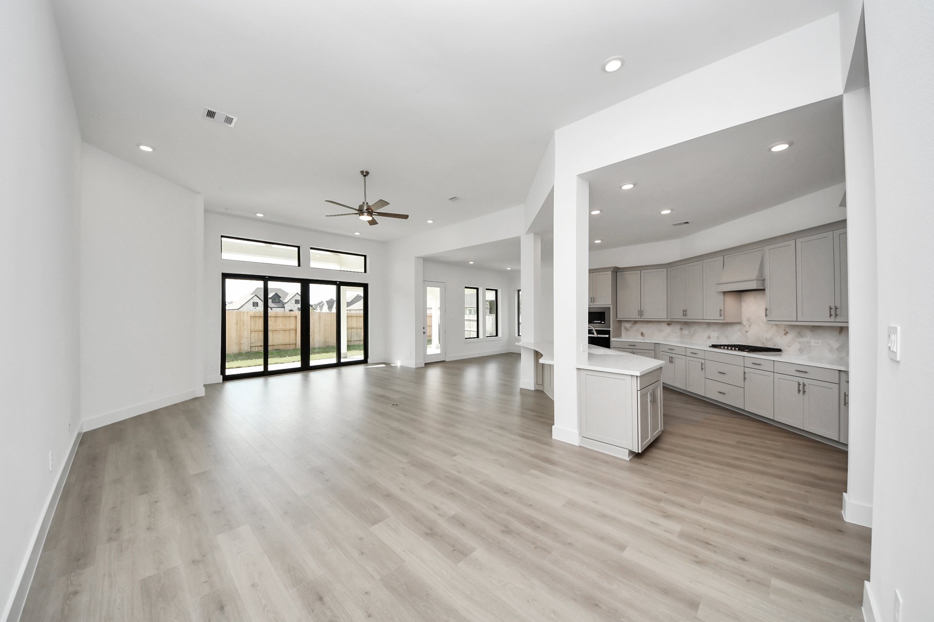 open-concept family room with large glass sliding door