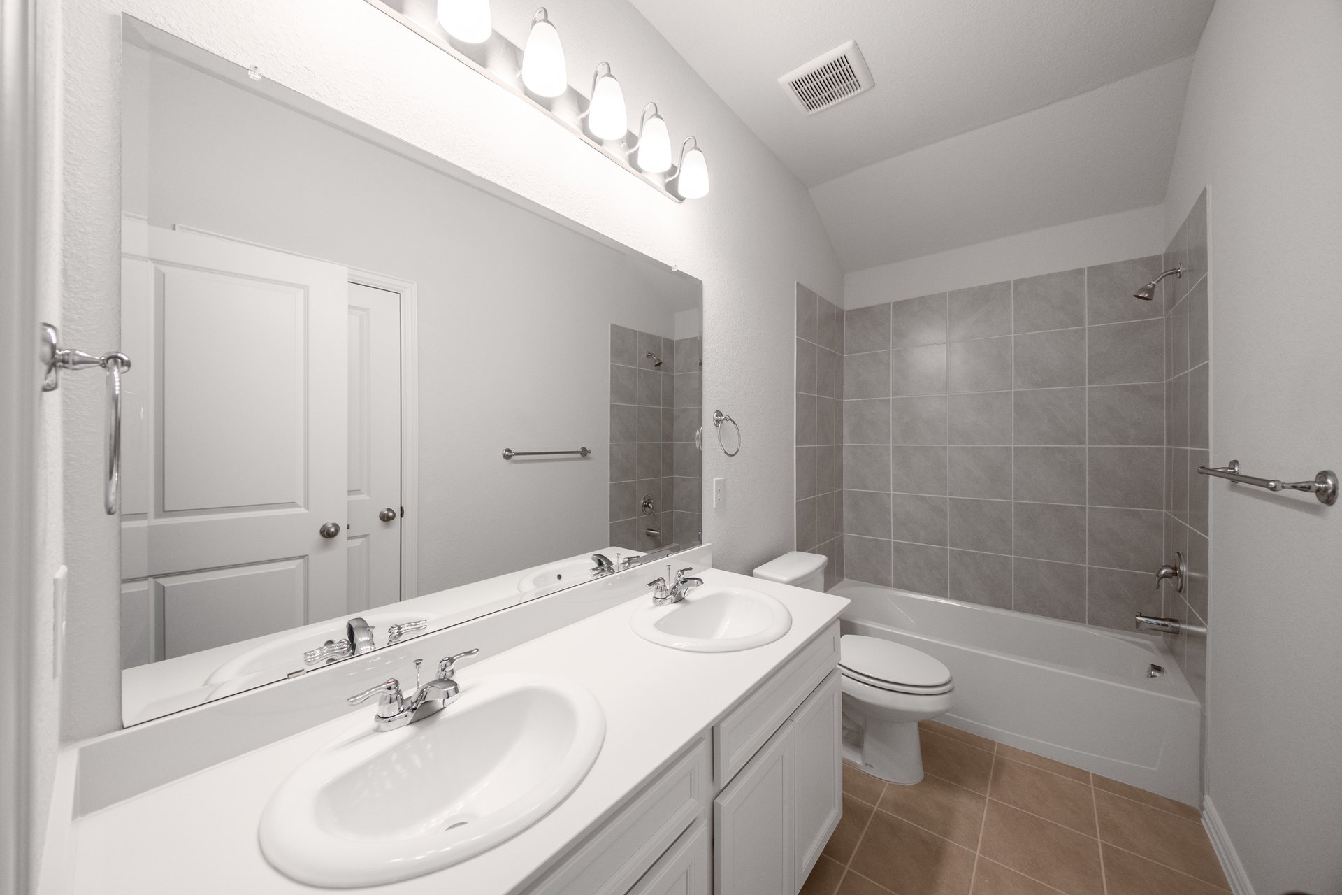 bathroom with two sinks and tile